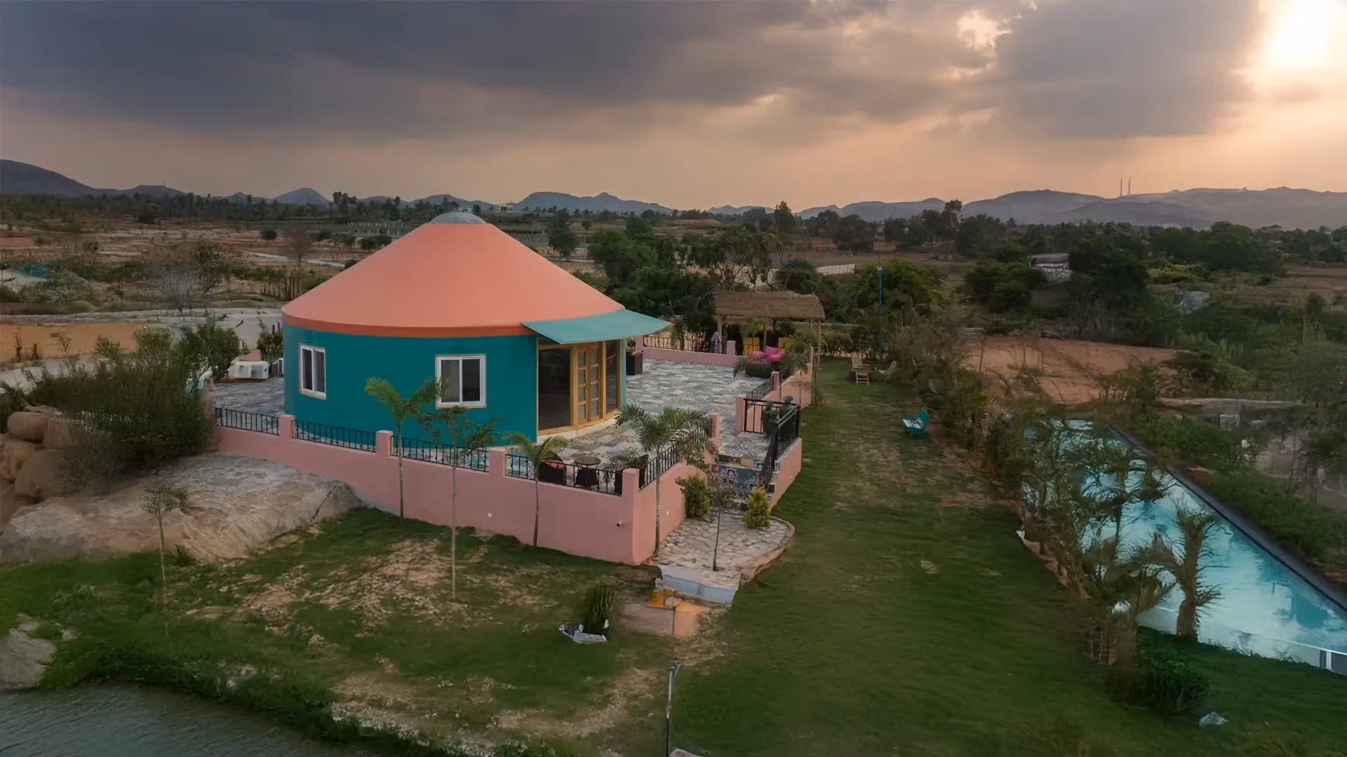 Yurt installation team assembling base structure in a rural landscape.