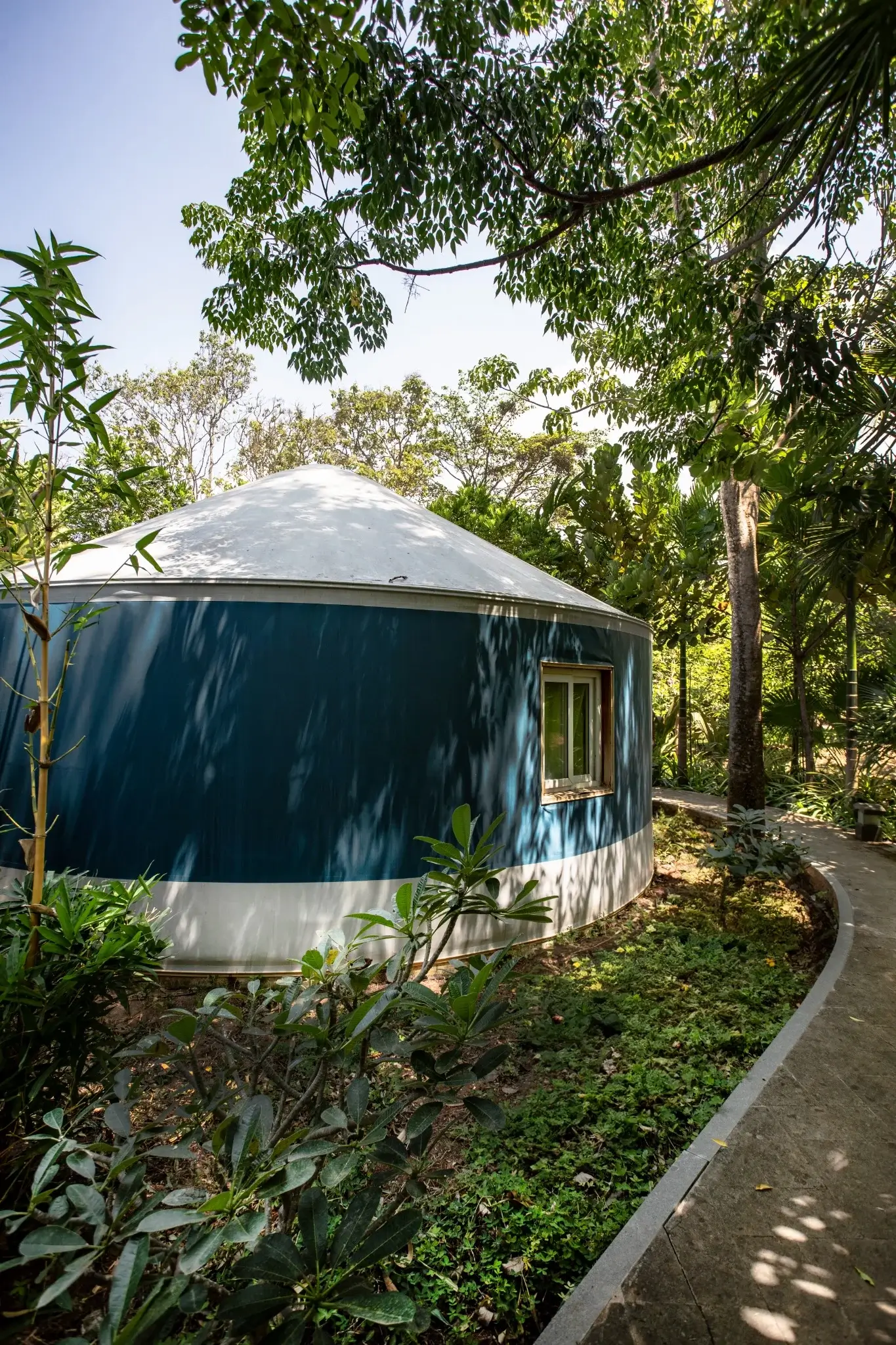 luxury yurts at eco-resort nestled in lush greenery, designed for upscale glamping experiences.