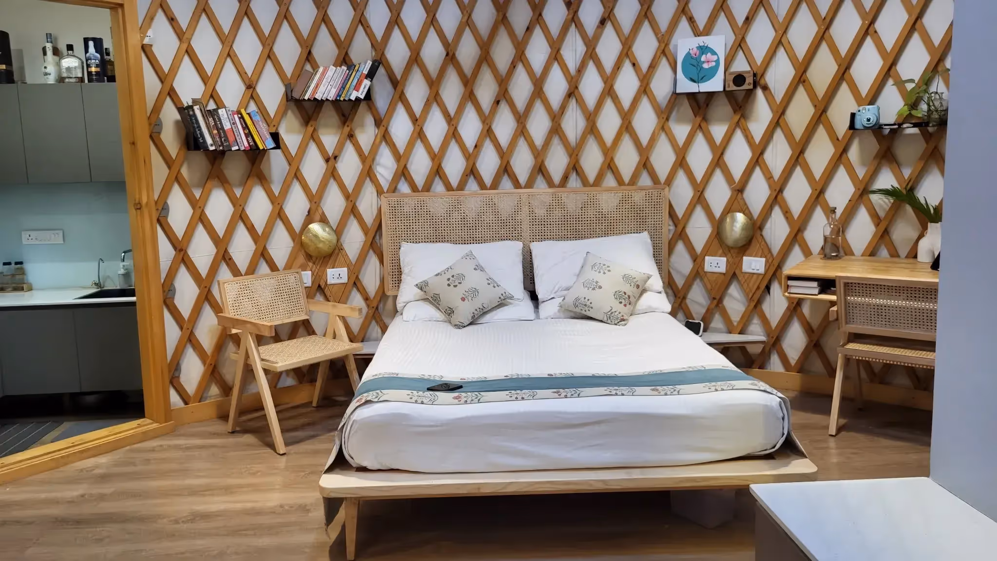 Spacious yurt bedroom with modern furniture, neutral tones, and a mix of contemporary and natural design elements.