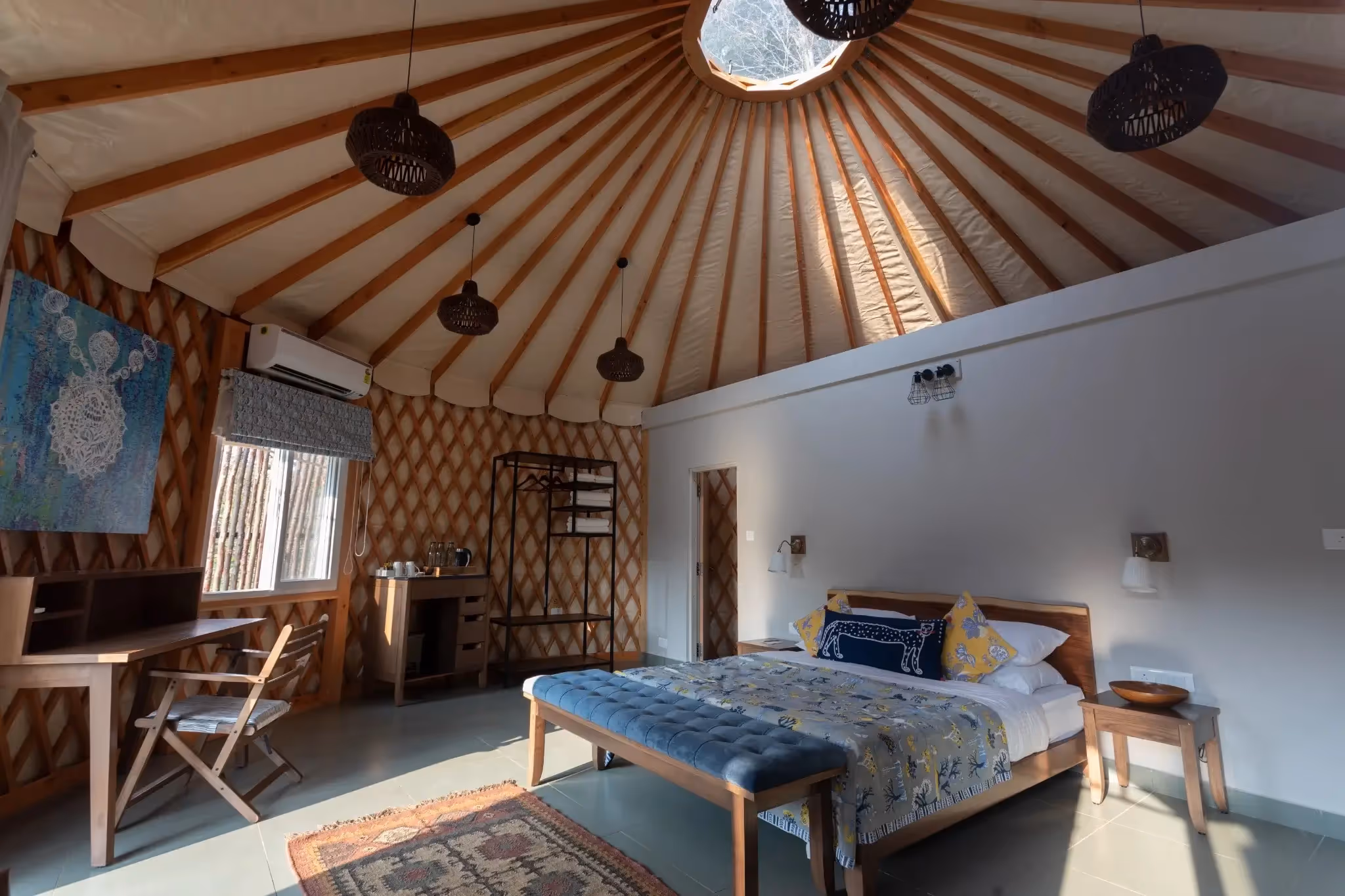 Minimalist luxury yurt bedroom with Scandinavian decor, large windows, and soft natural lighting.