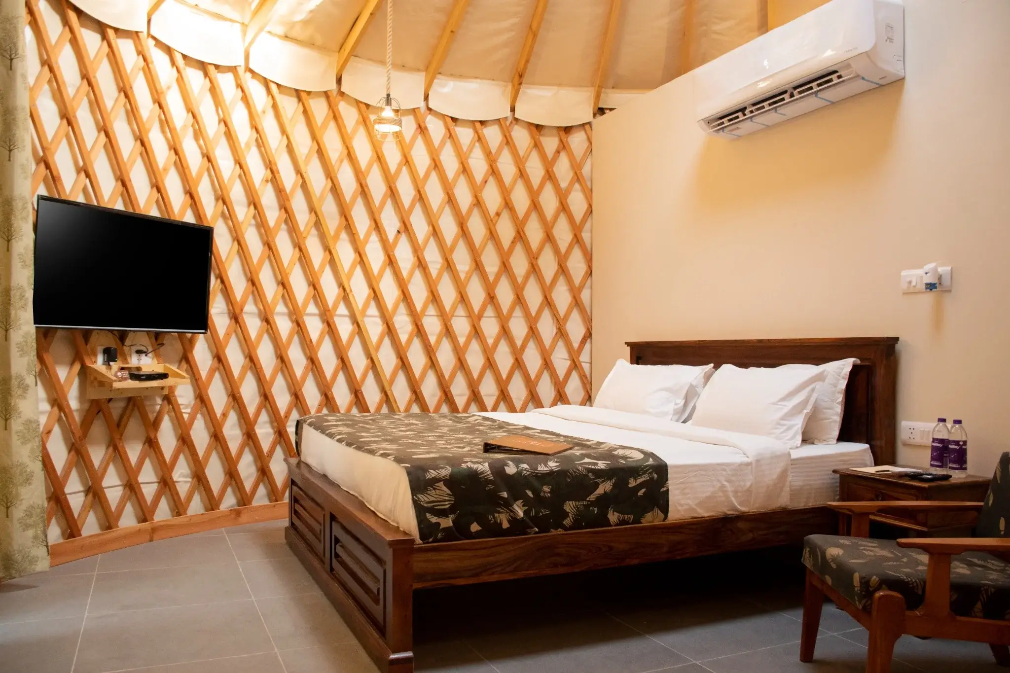 Interior view of a luxury yurt bedroom with cozy furnishings