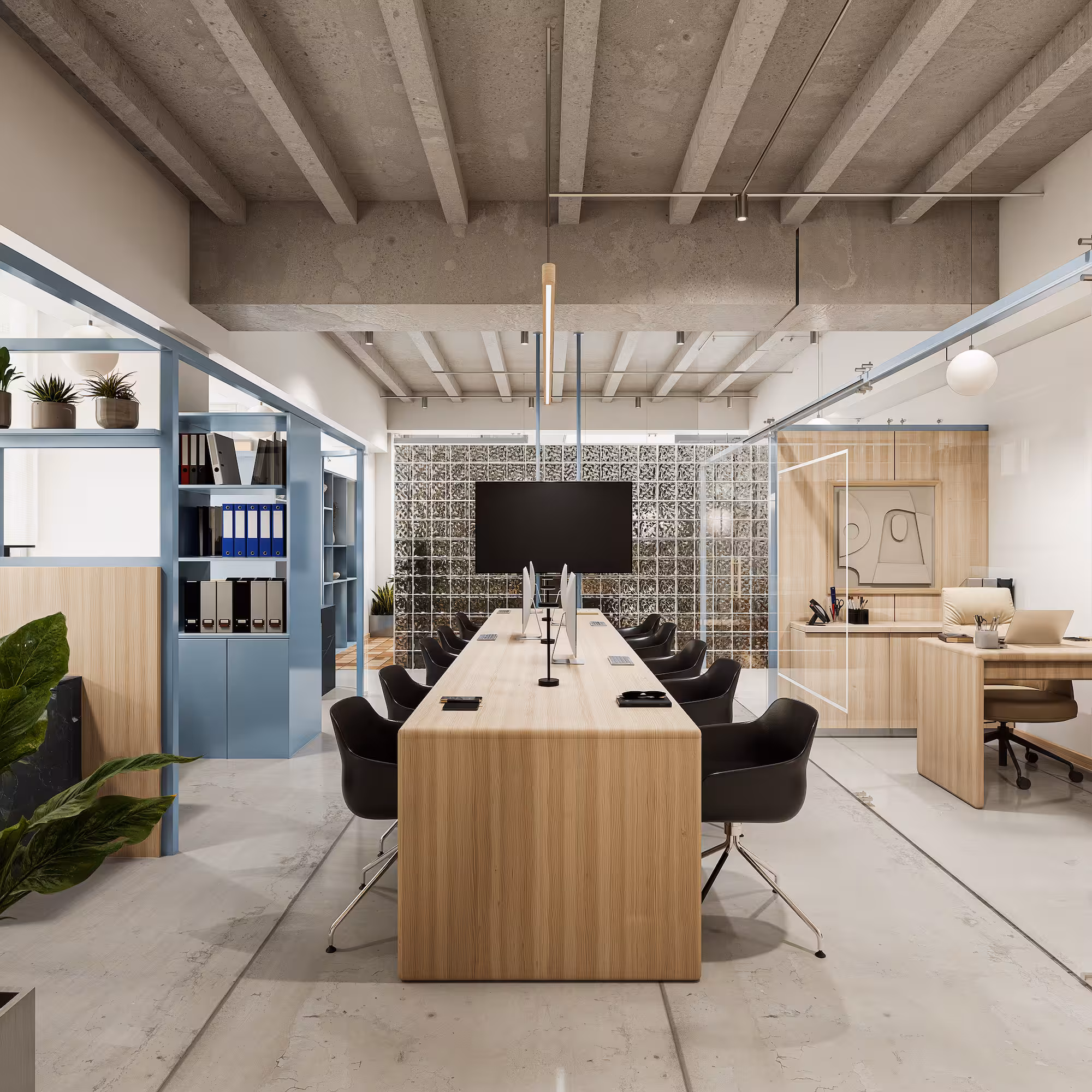 Oficina moderna con mesa de trabajo central, sillas negras, estantes y escritorios de madera clara.