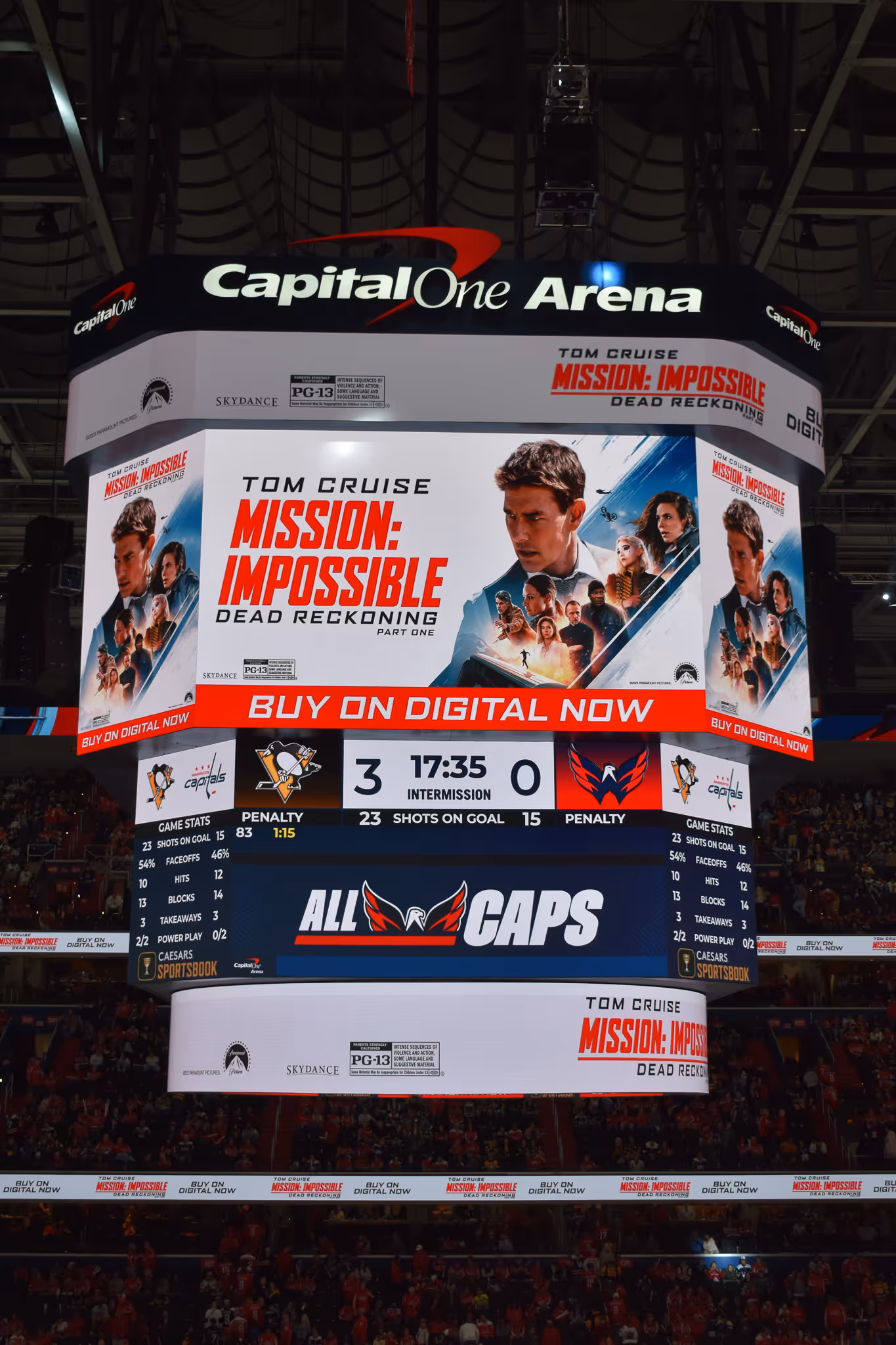 Capital One Arena scoreboard showing a 3-0 hockey game score during intermission and an ad for Tom Cruise's Mission: Impossible Dead Reckoning Part One.