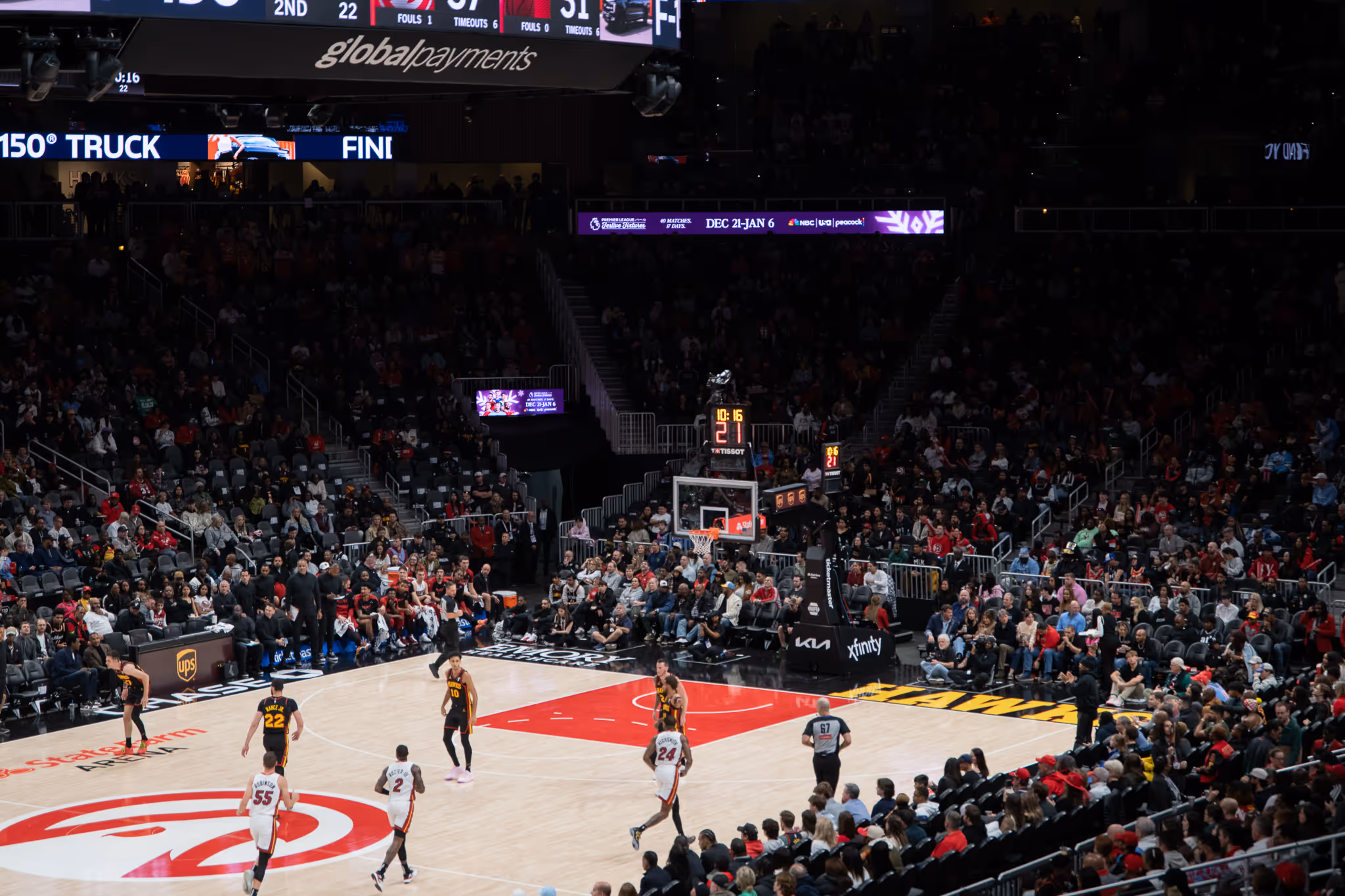 Basketball game featuring Atlanta Hawks playing against Miami Heat at State Farm Arena with crowd in the stands.