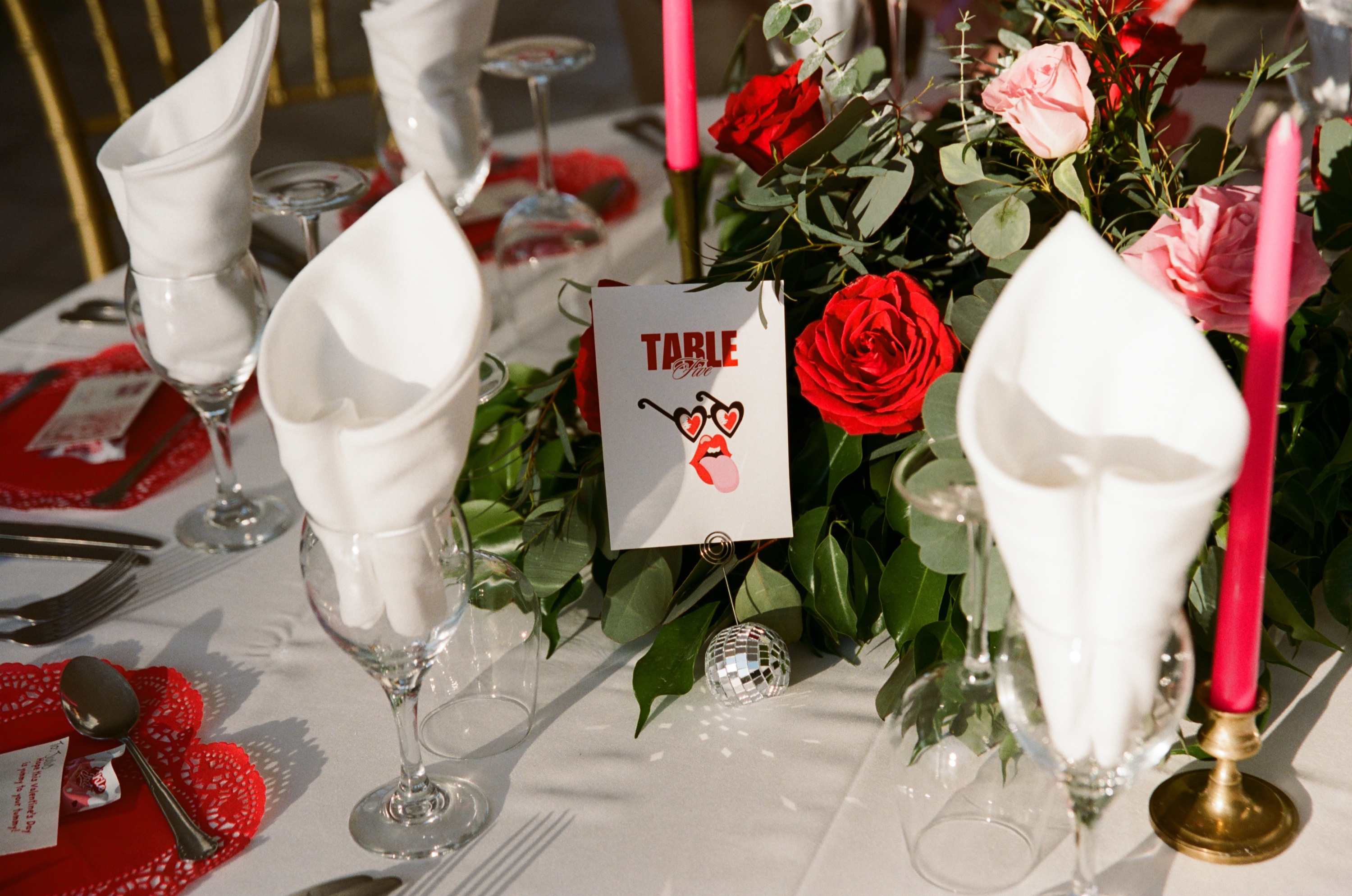 TABLE heart card with disco ball roses and candles at wedding reception table setting