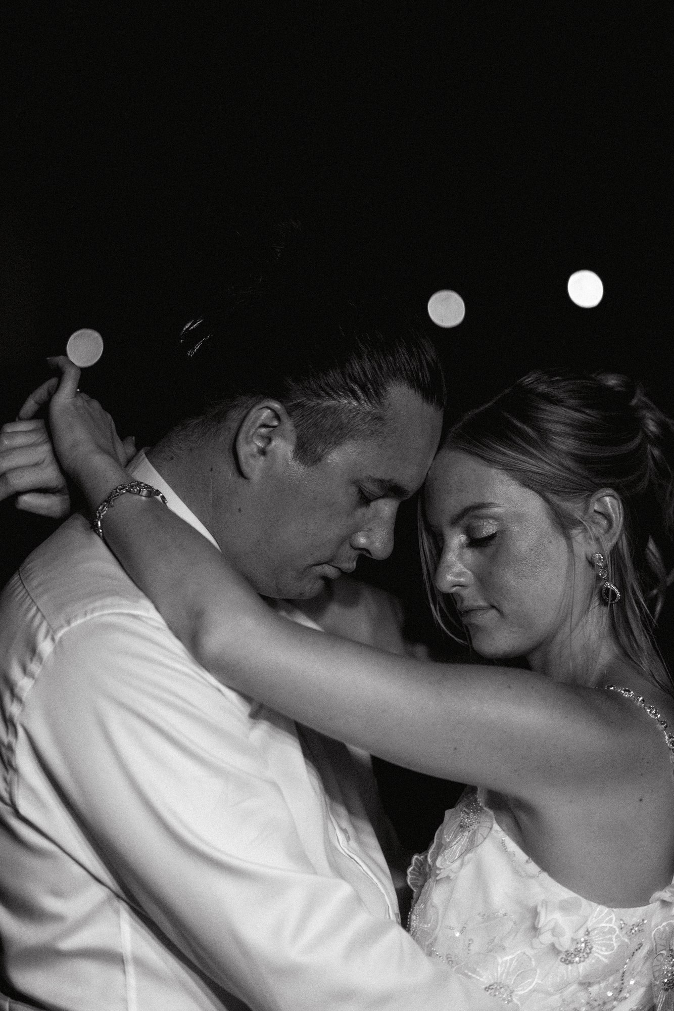 Intimate first dance embrace in black and white