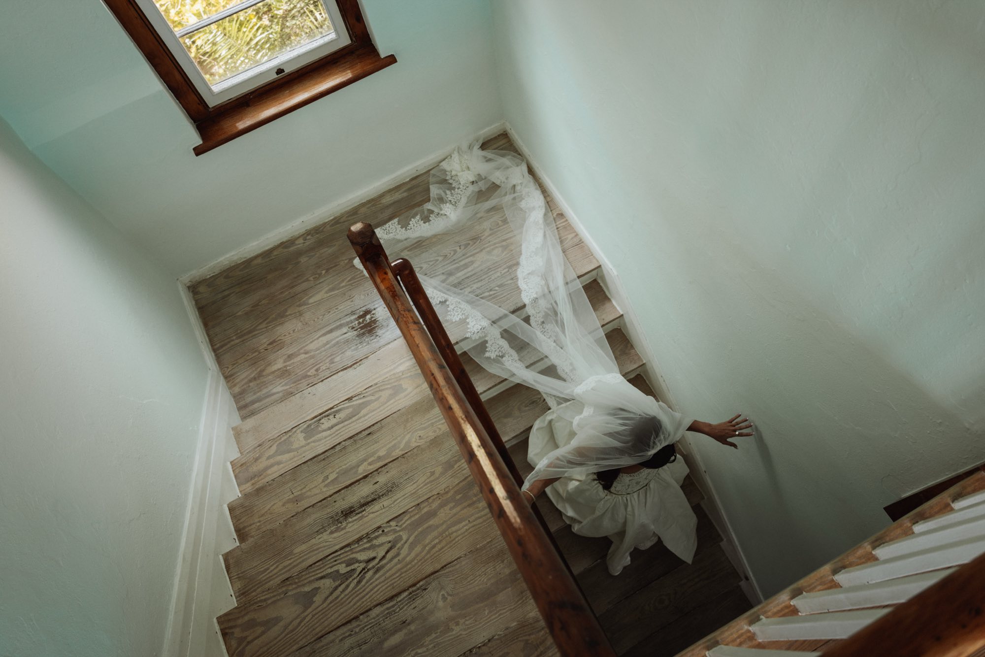 High angle photograph of bride's trailing lace veil during getting ready