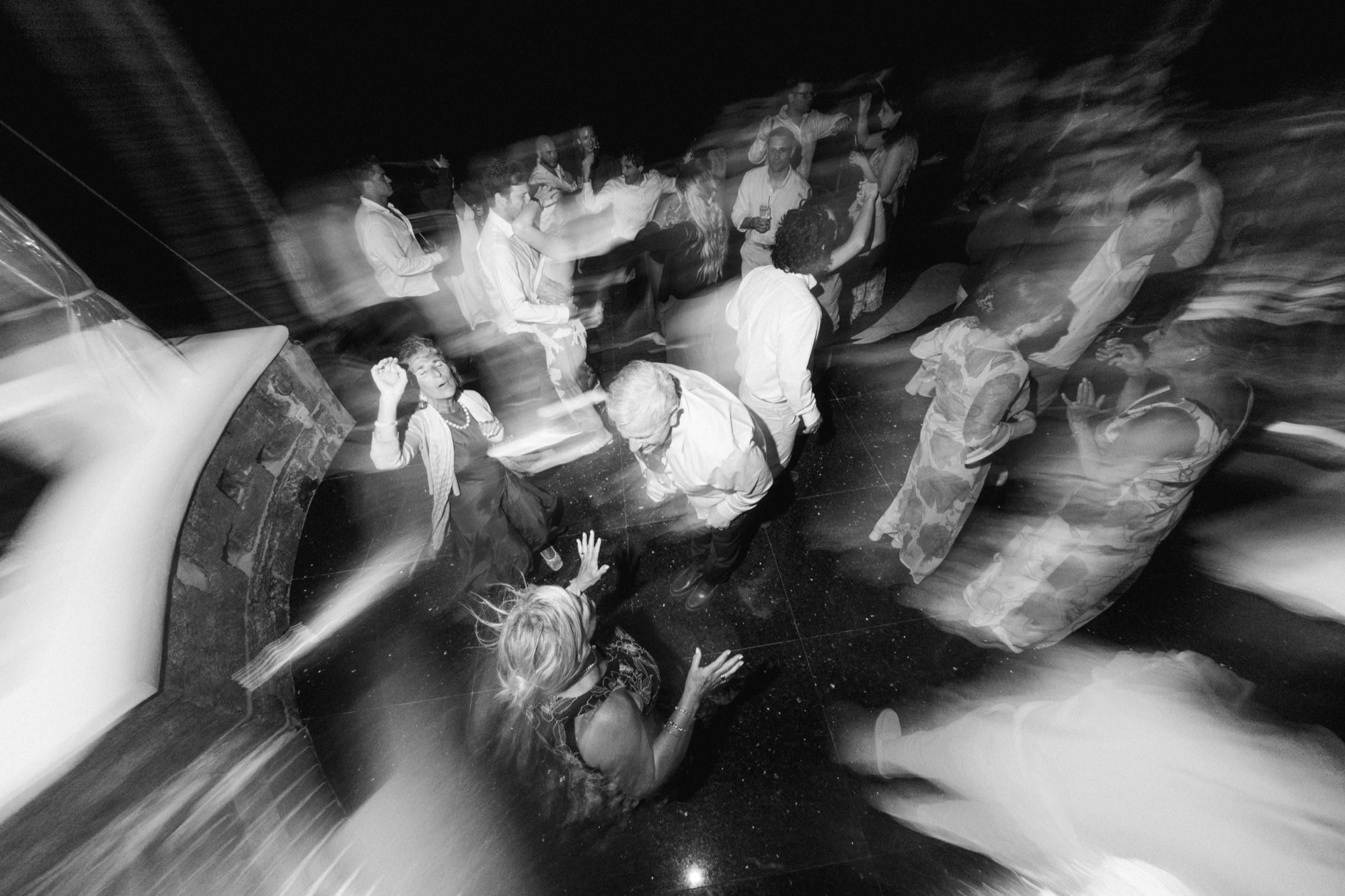 Black and white slow shutter motion blur on outdoor wedding dance floor