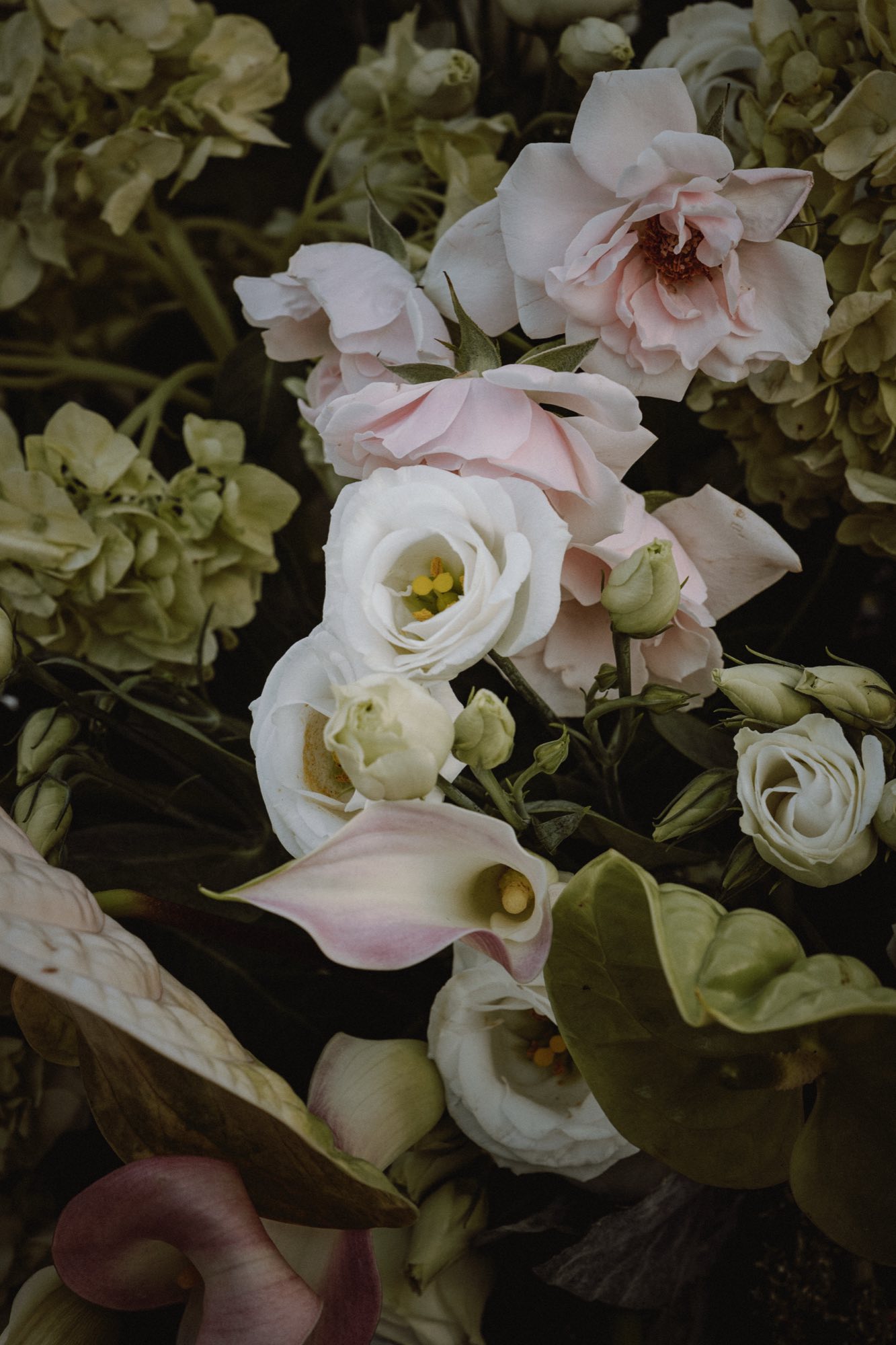 Muted organic floral arrangement with soft textures at wedding reception
