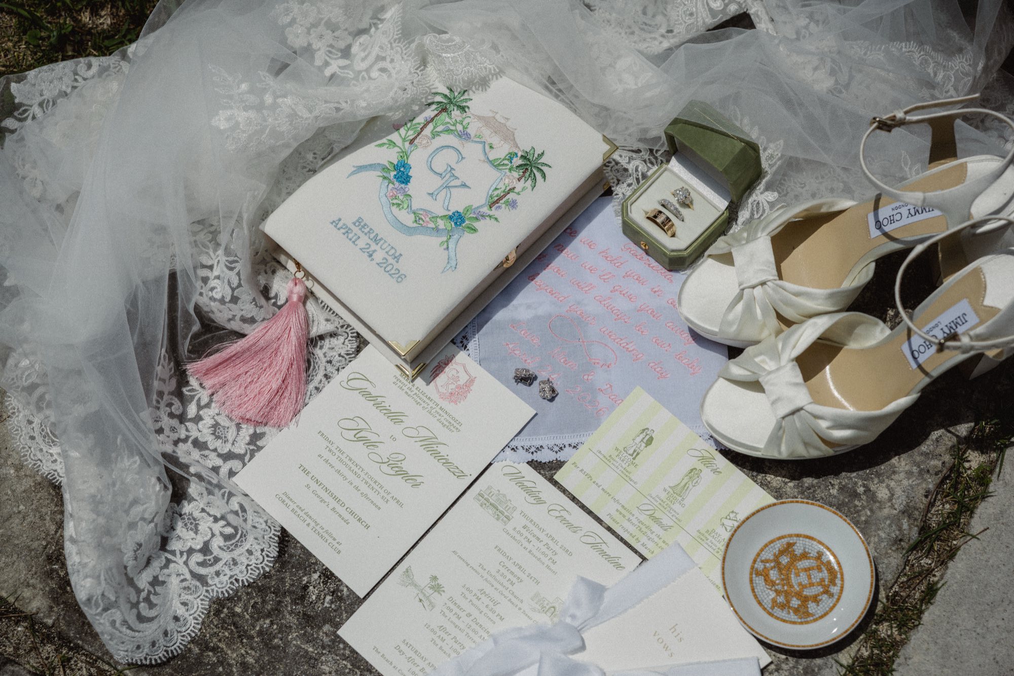 Flat lay of green velvet ring box and bridal accessories at Bermuda wedding