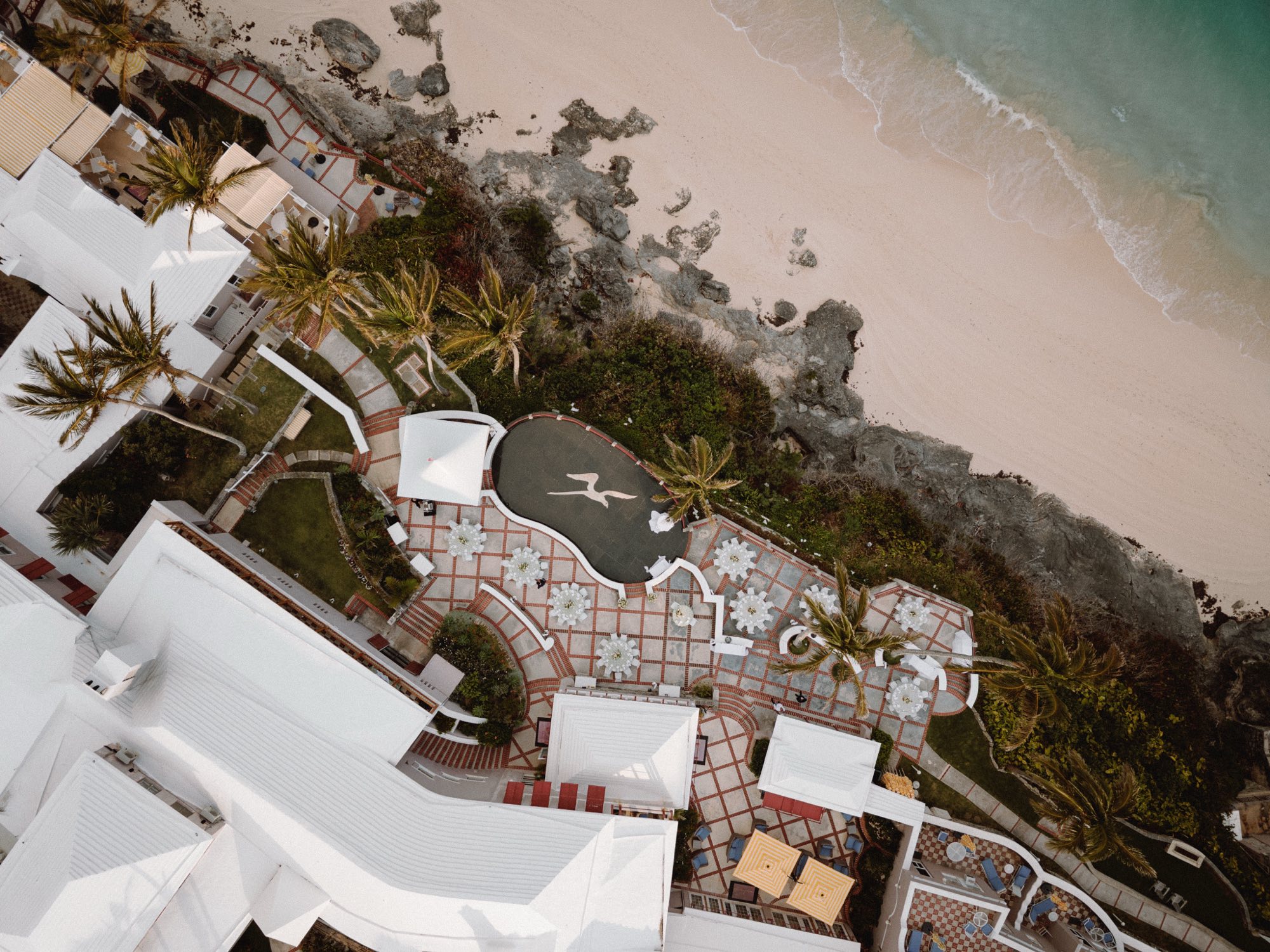 Aerial view of coastal Bermuda wedding reception layout on cliffside
