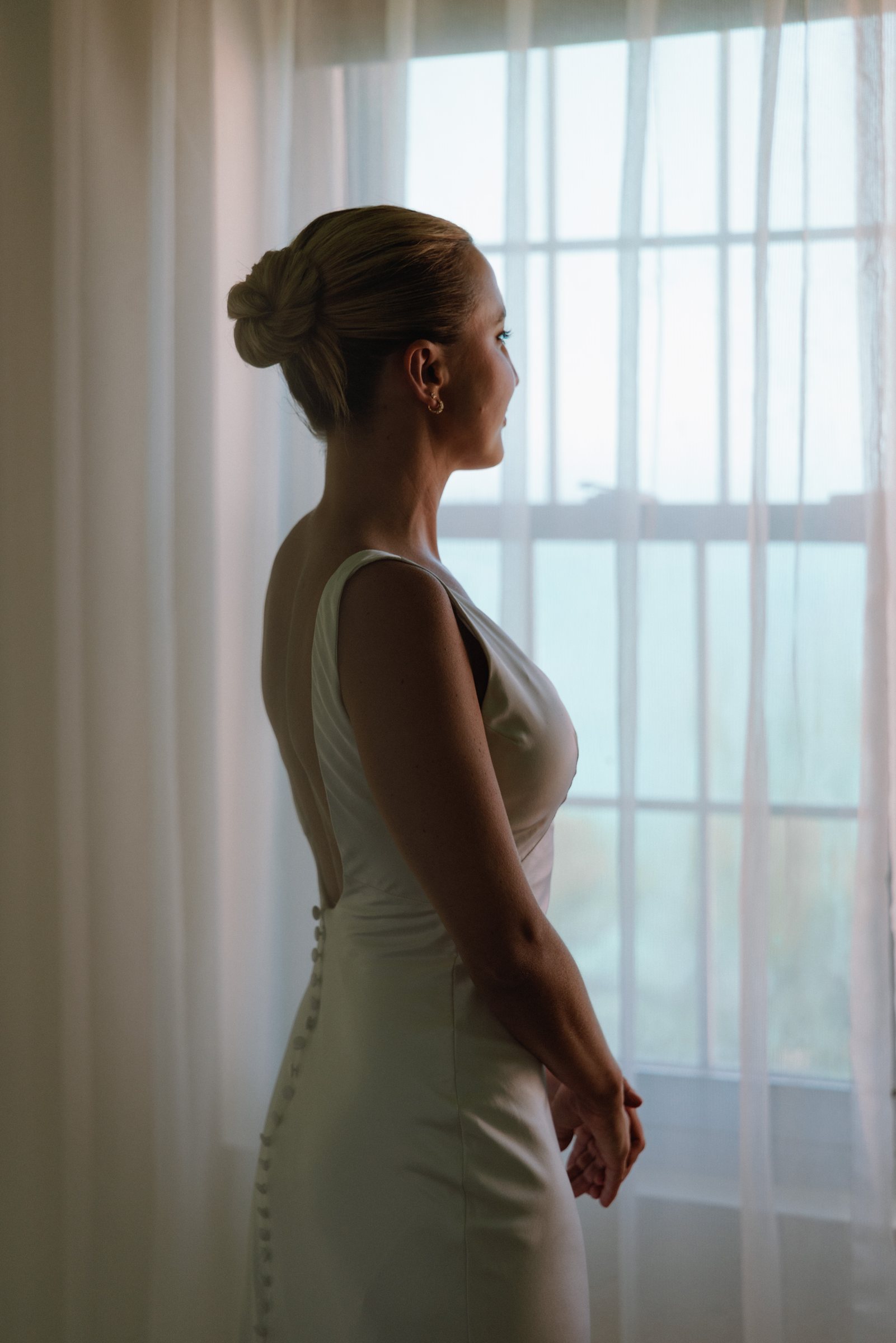 Bride in soft window light during getting ready at a Bermuda wedding