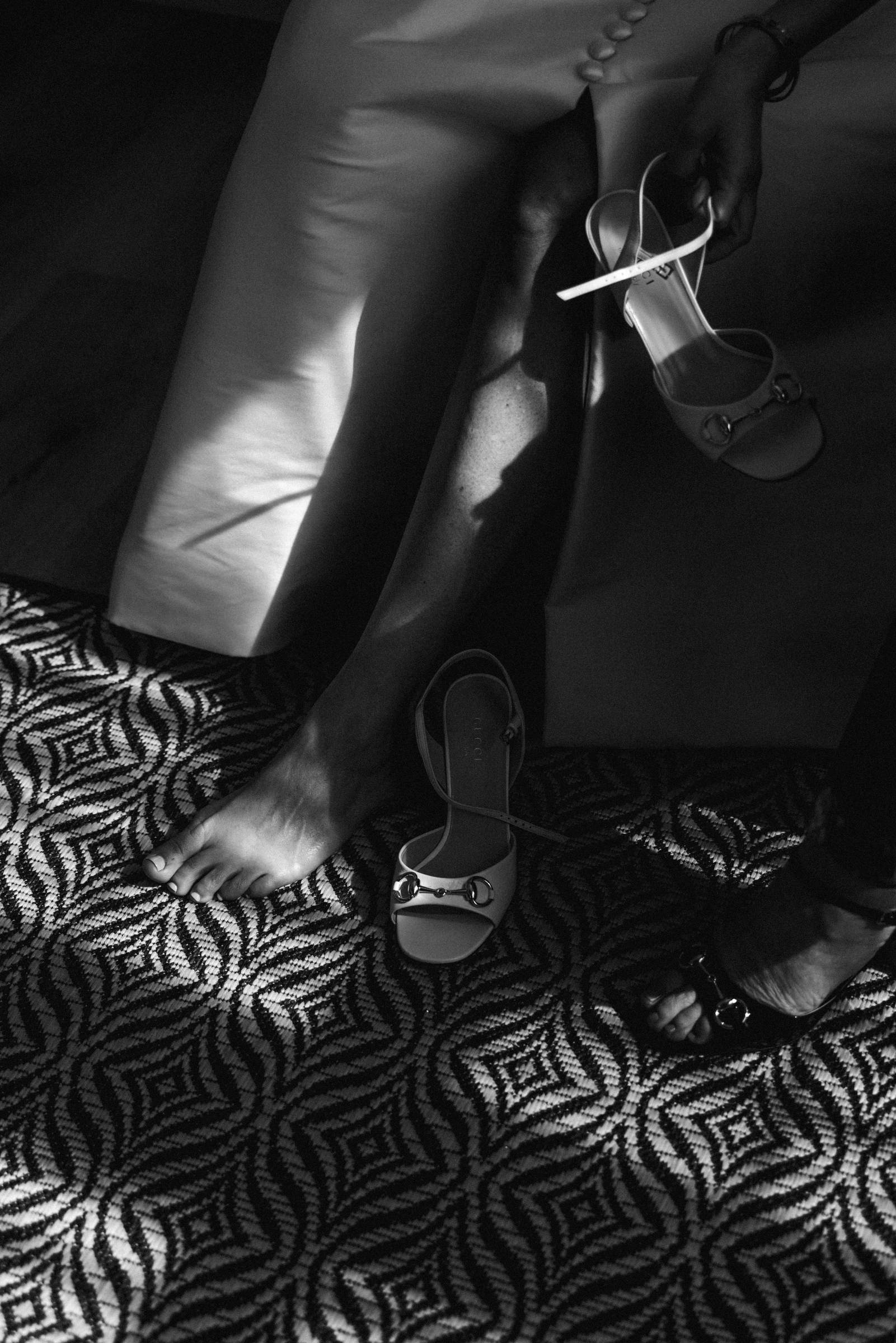 Black and white detail of bridal shoes on a patterned tile floor