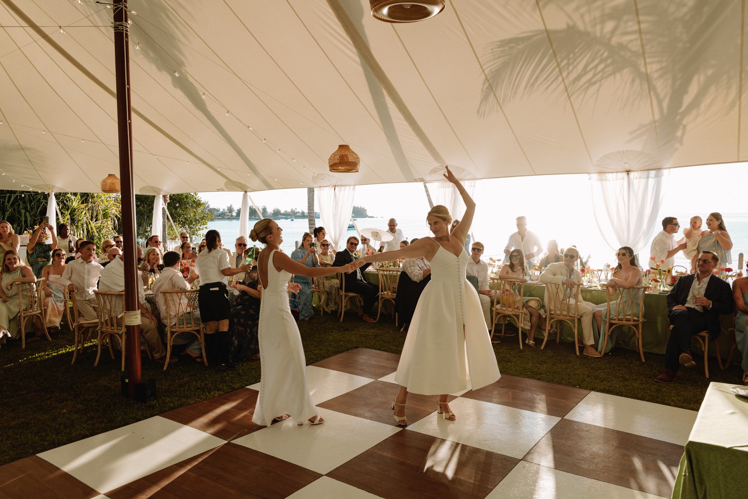First dance on a checkerboard floor inside a sailcloth tent at a Bermuda wedding