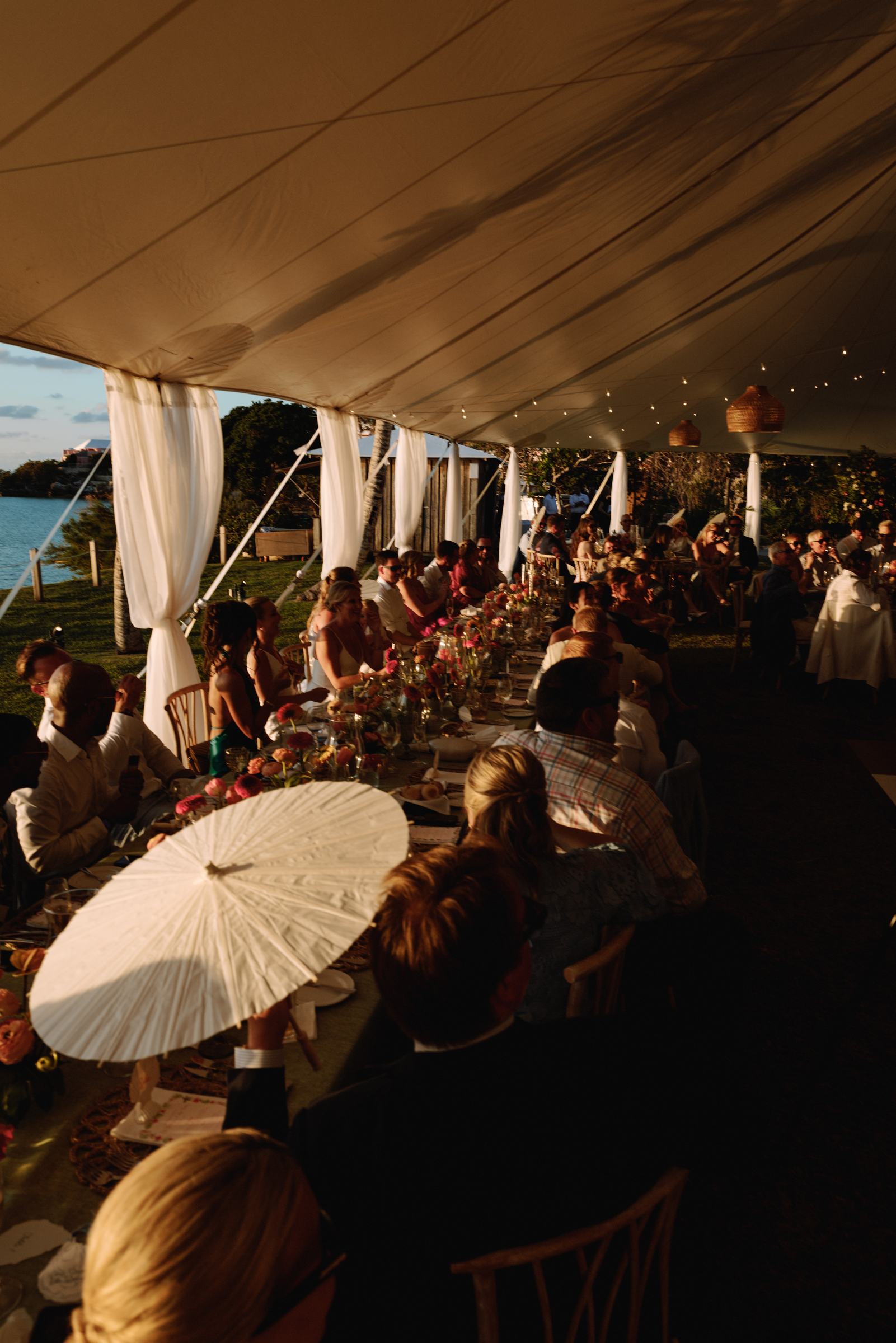 Warm evening dinner under the sailcloth tent with paper parasols on the tables