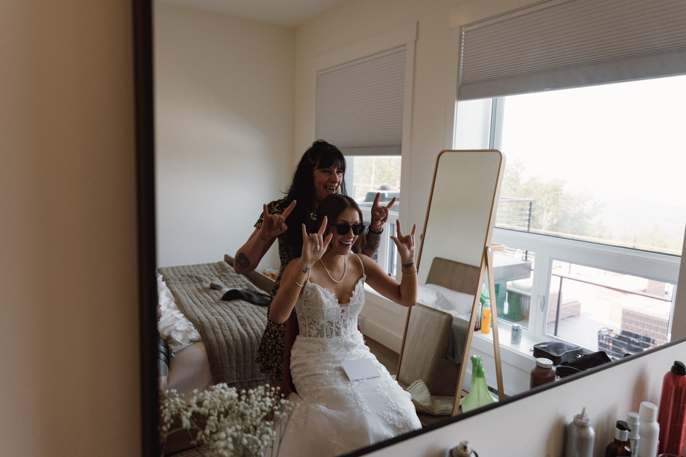 Bride and her friends messing around in the mirror during getting ready