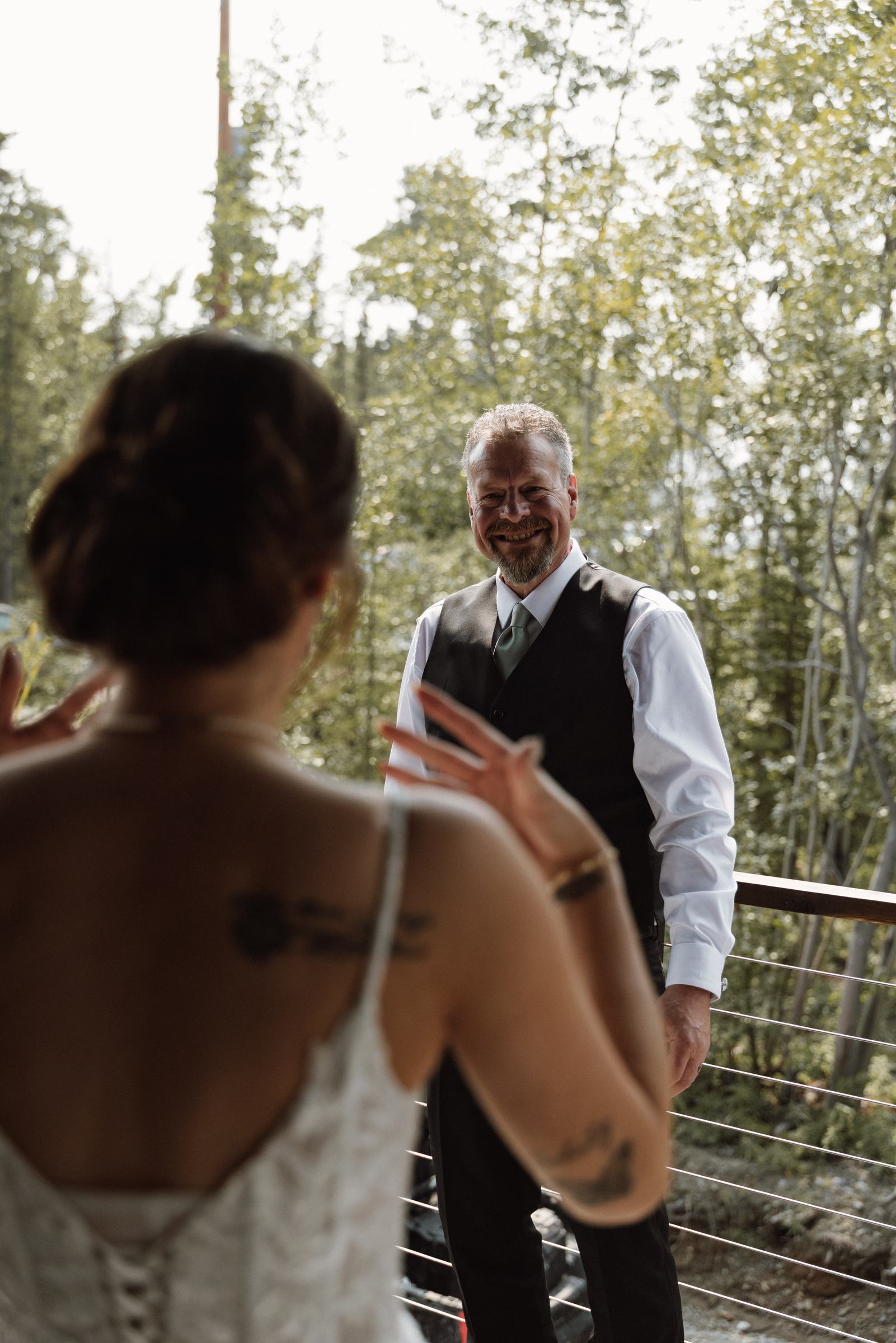 Bride walking in on her father's arm before a mountaintop ceremony