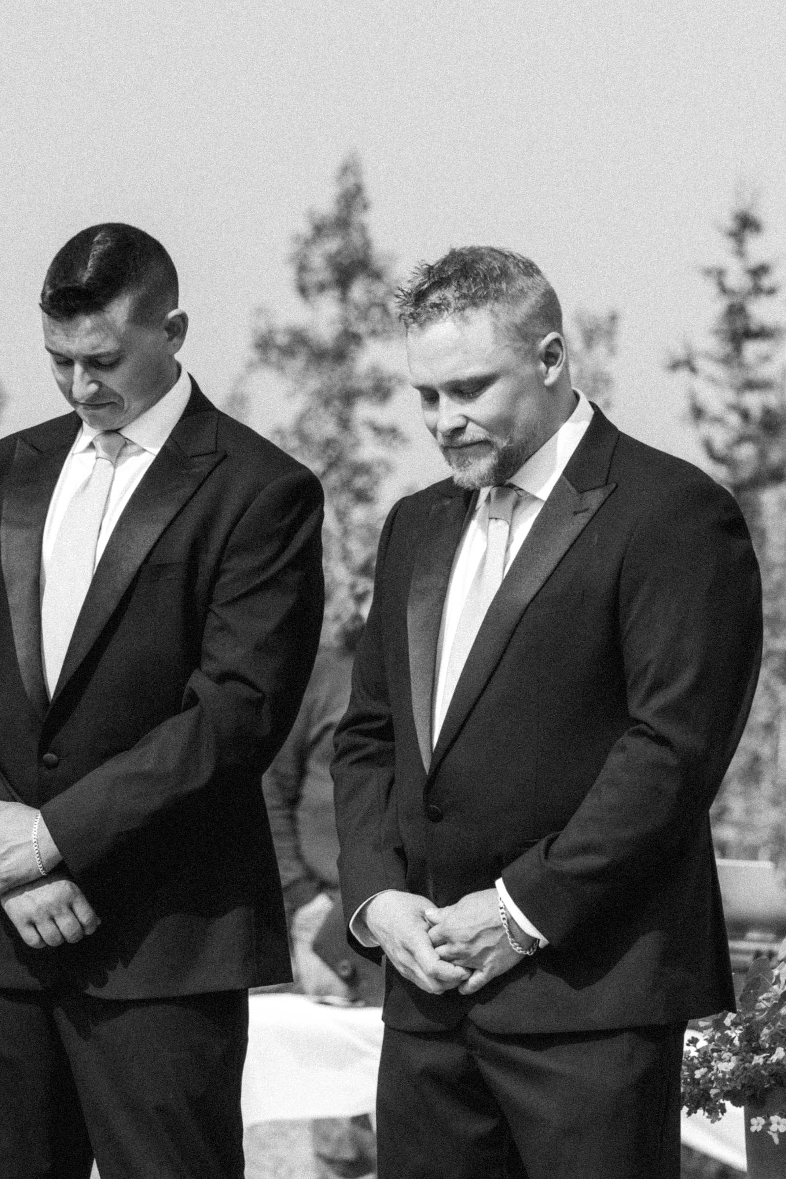 Black and white photograph of the groom and his best man waiting at the altar