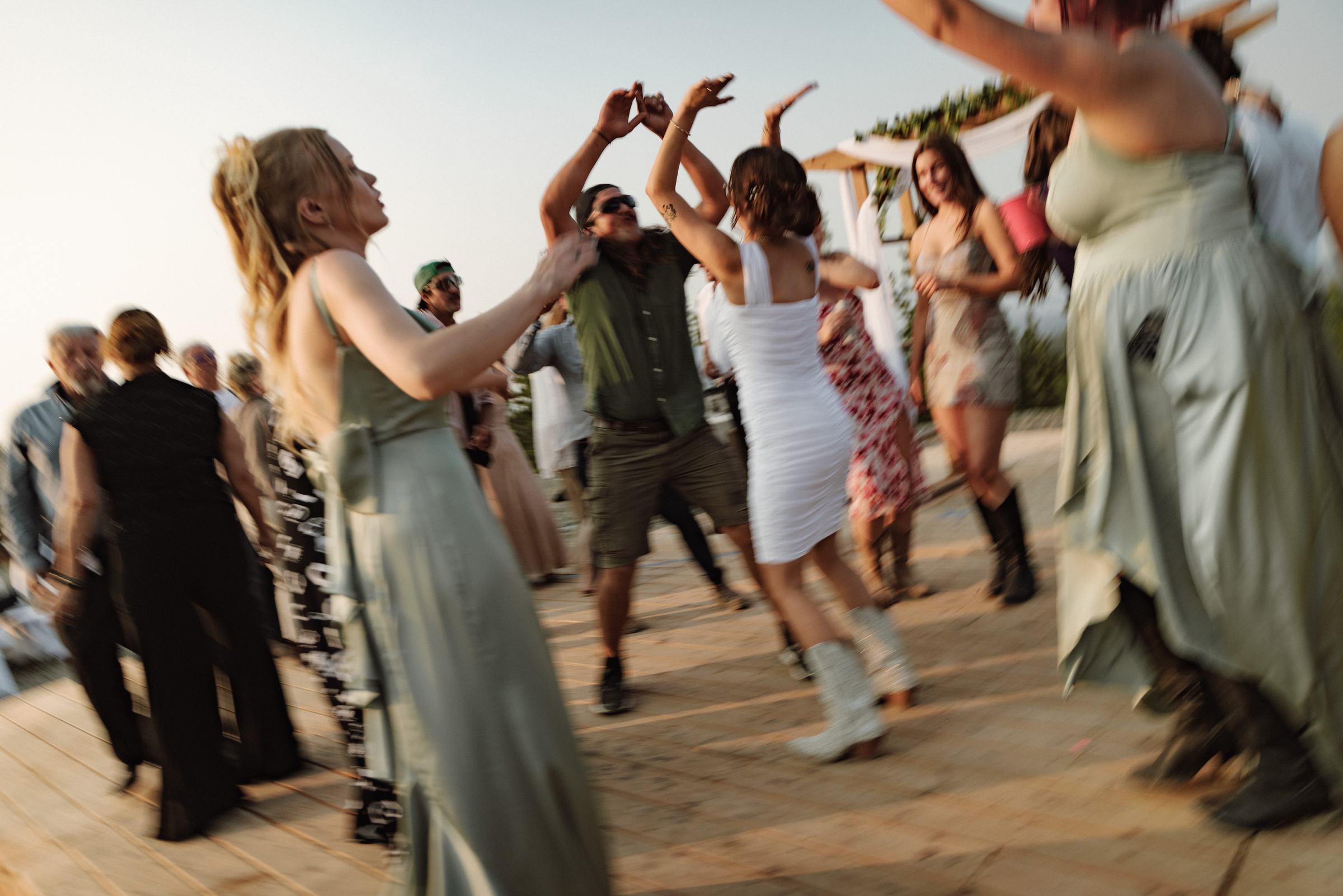 Packed dance floor on the deck at a mountaintop wedding reception