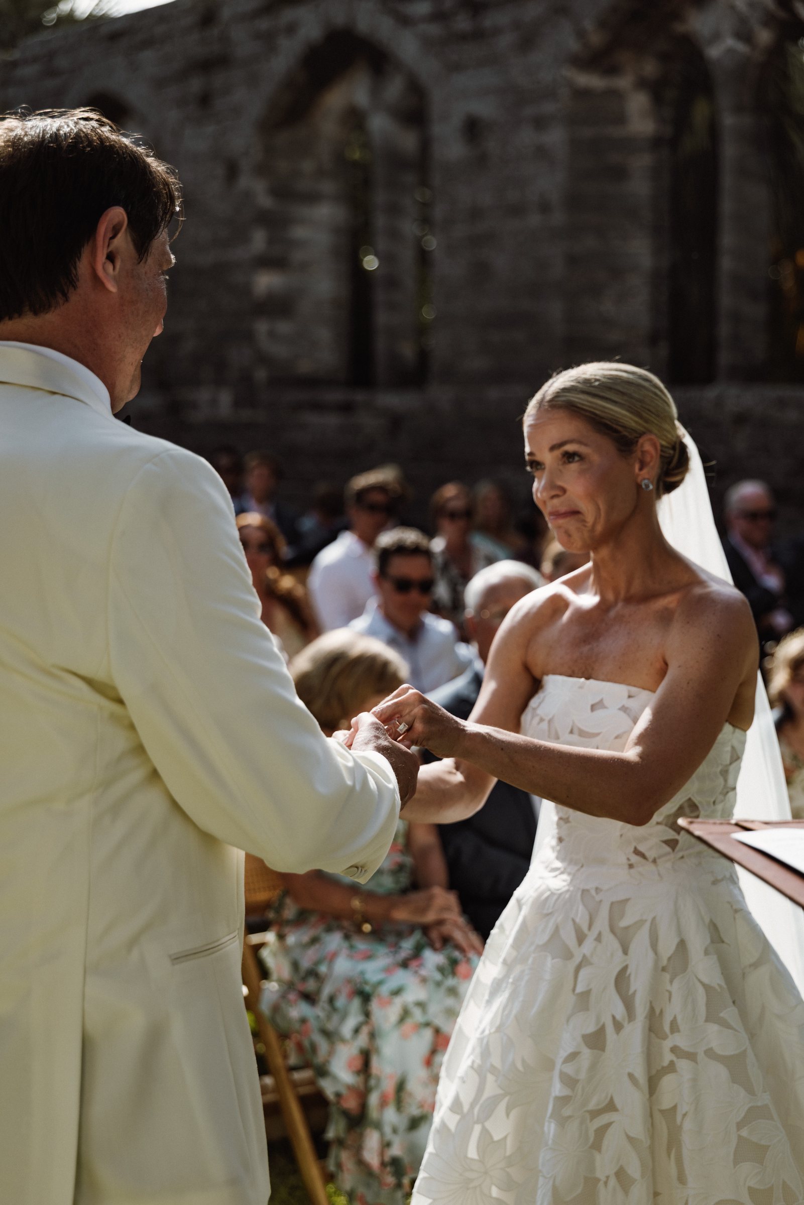 Bride and groom holding hands during their vows at a Bermuda wedding
