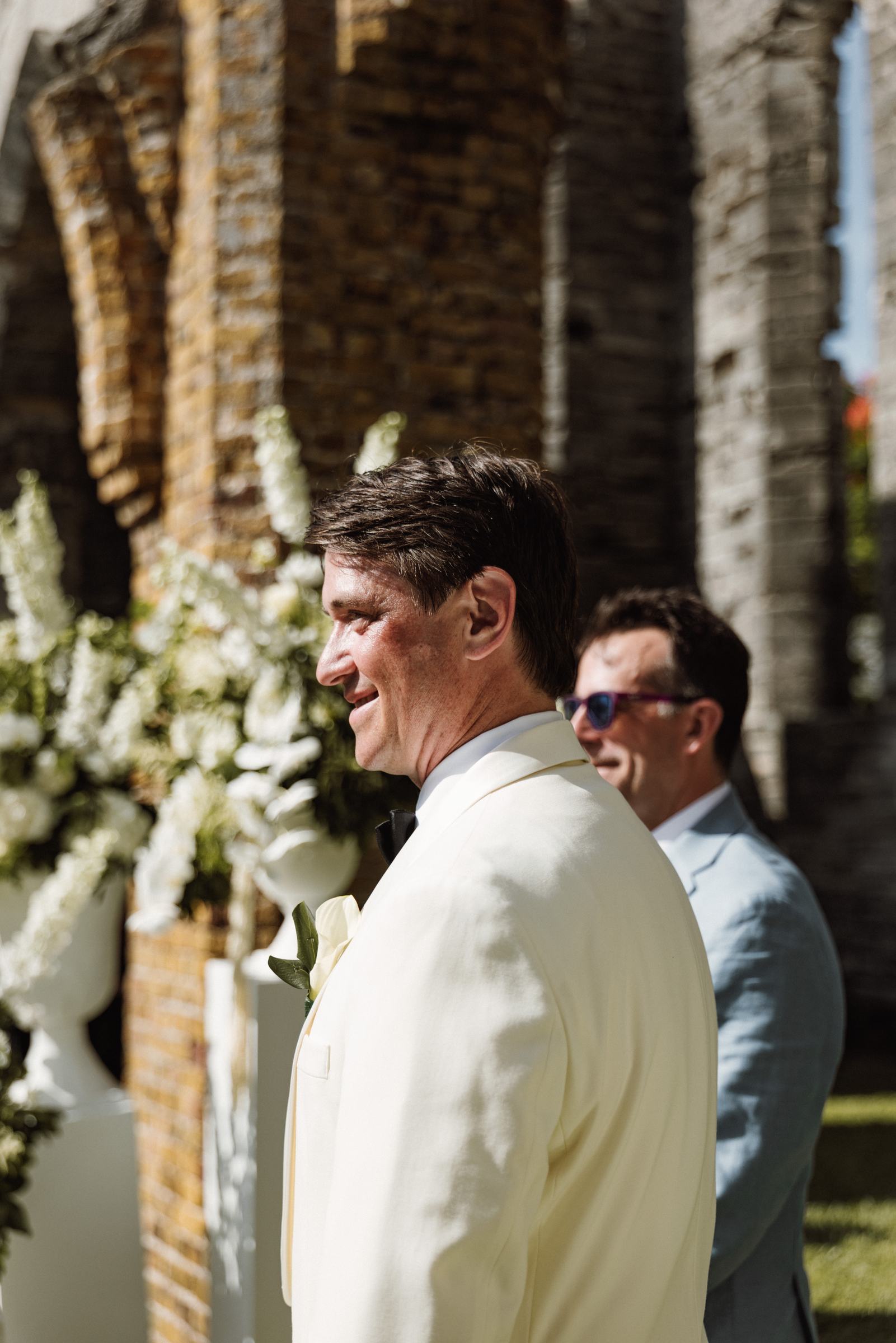 Groom watching his bride walk down the aisle at the Bermuda church ruins