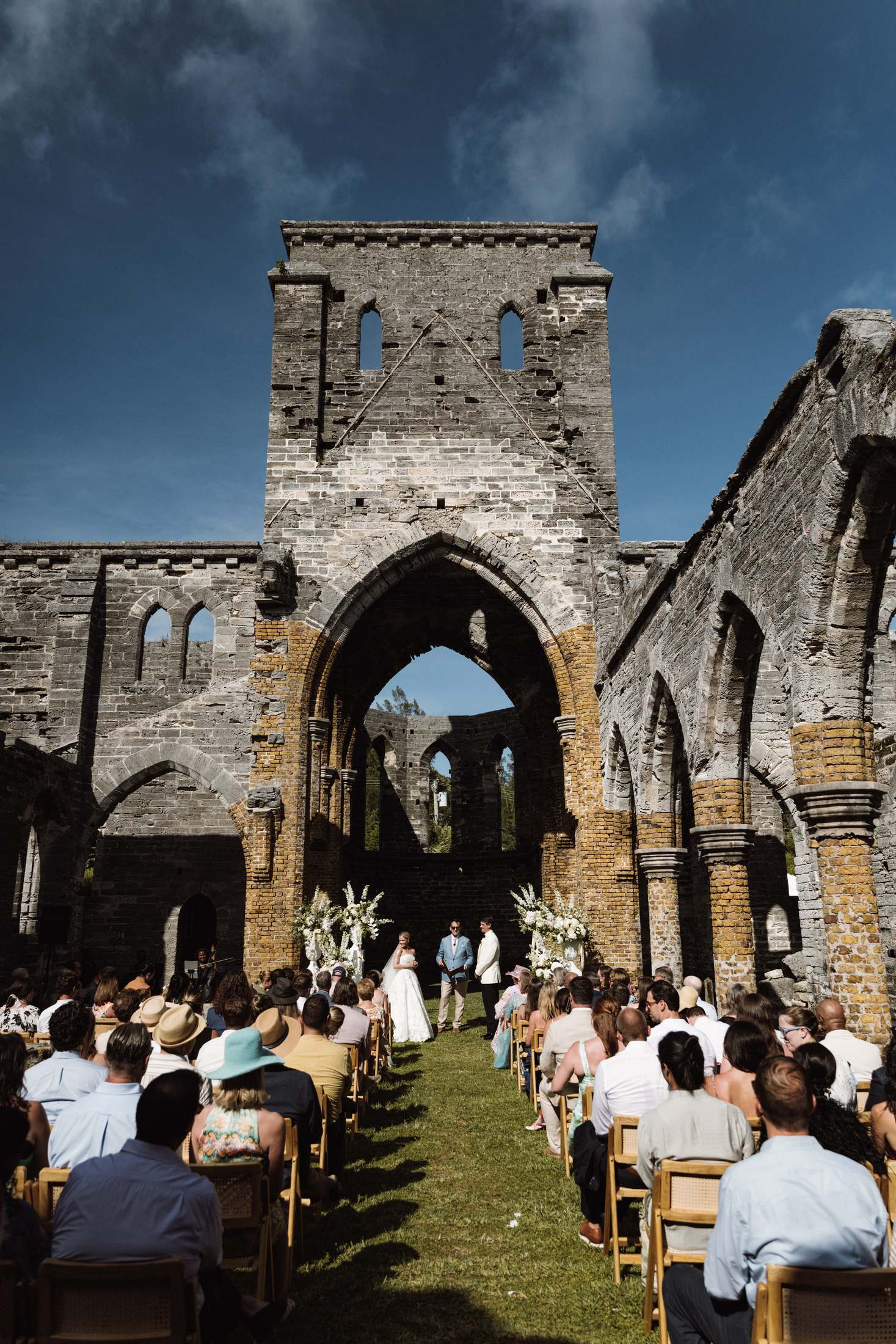 Ceremony seen from the back of the aisle inside the roofless Bermuda church ruins