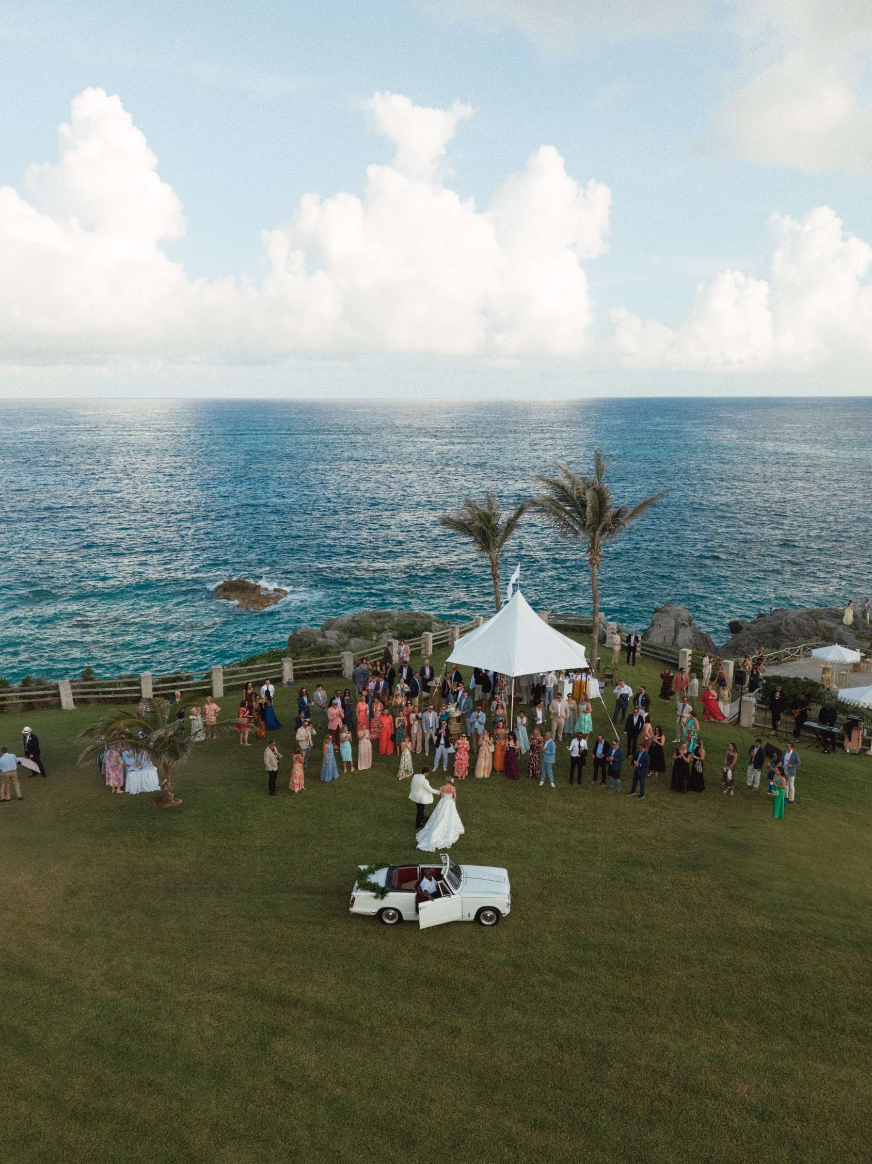 Guests gathered on the lawn above the Bermuda ocean before dinner