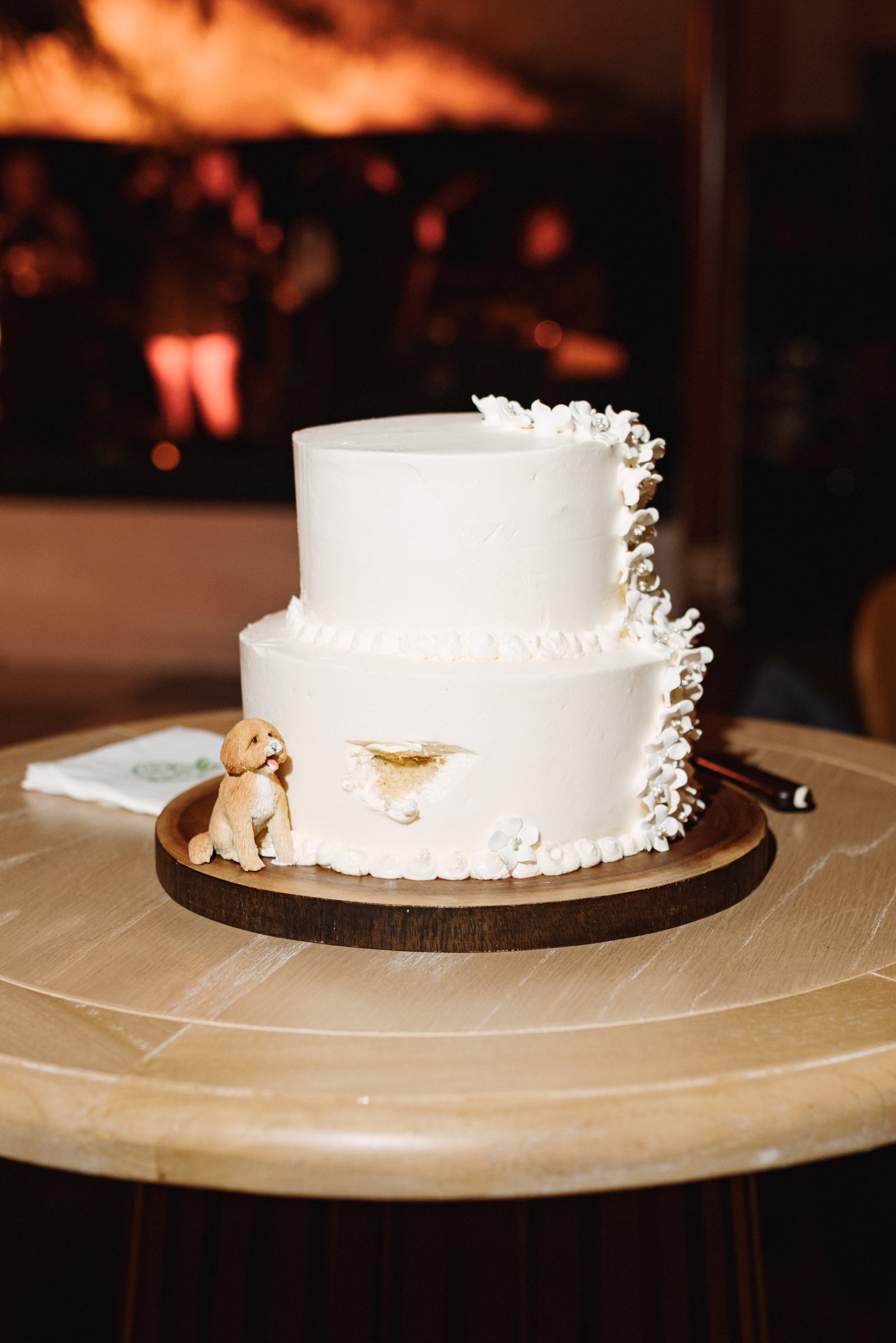 Simple white wedding cake in warm light at a Bermuda reception