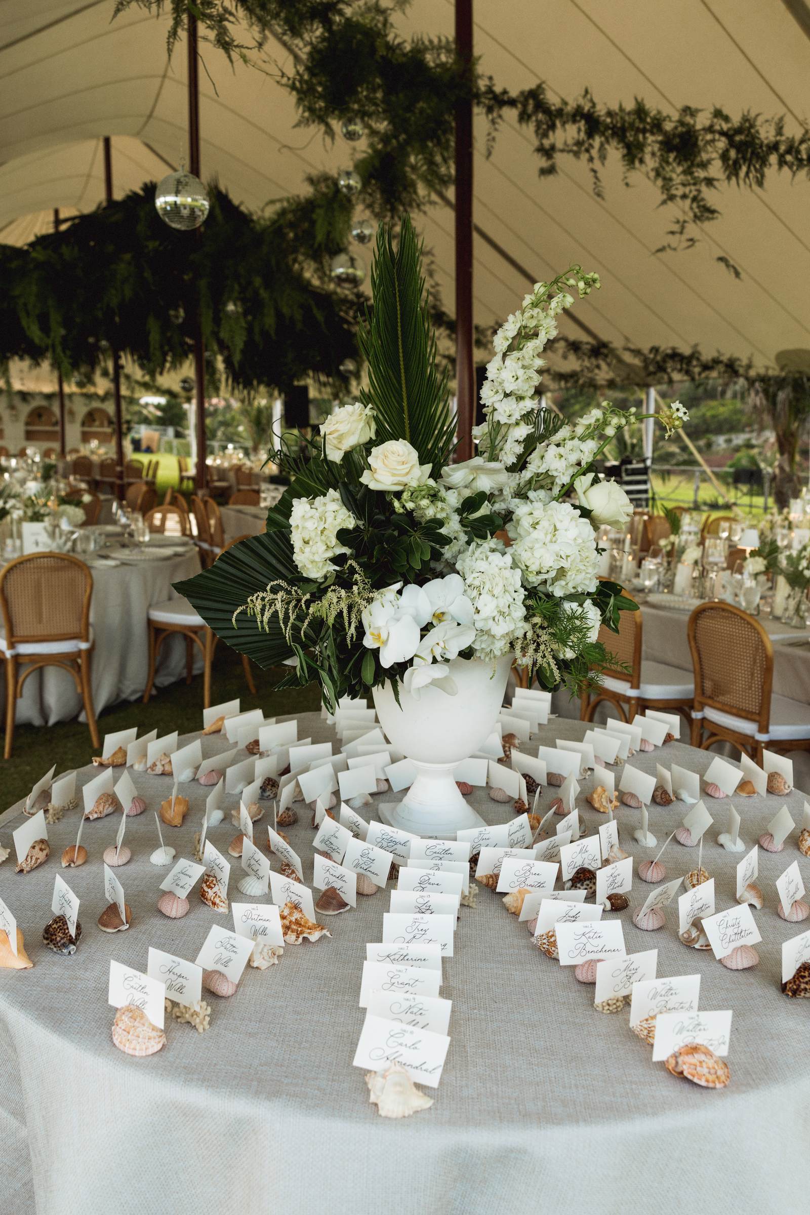 Escort card table dressed with white florals at a Bermuda wedding