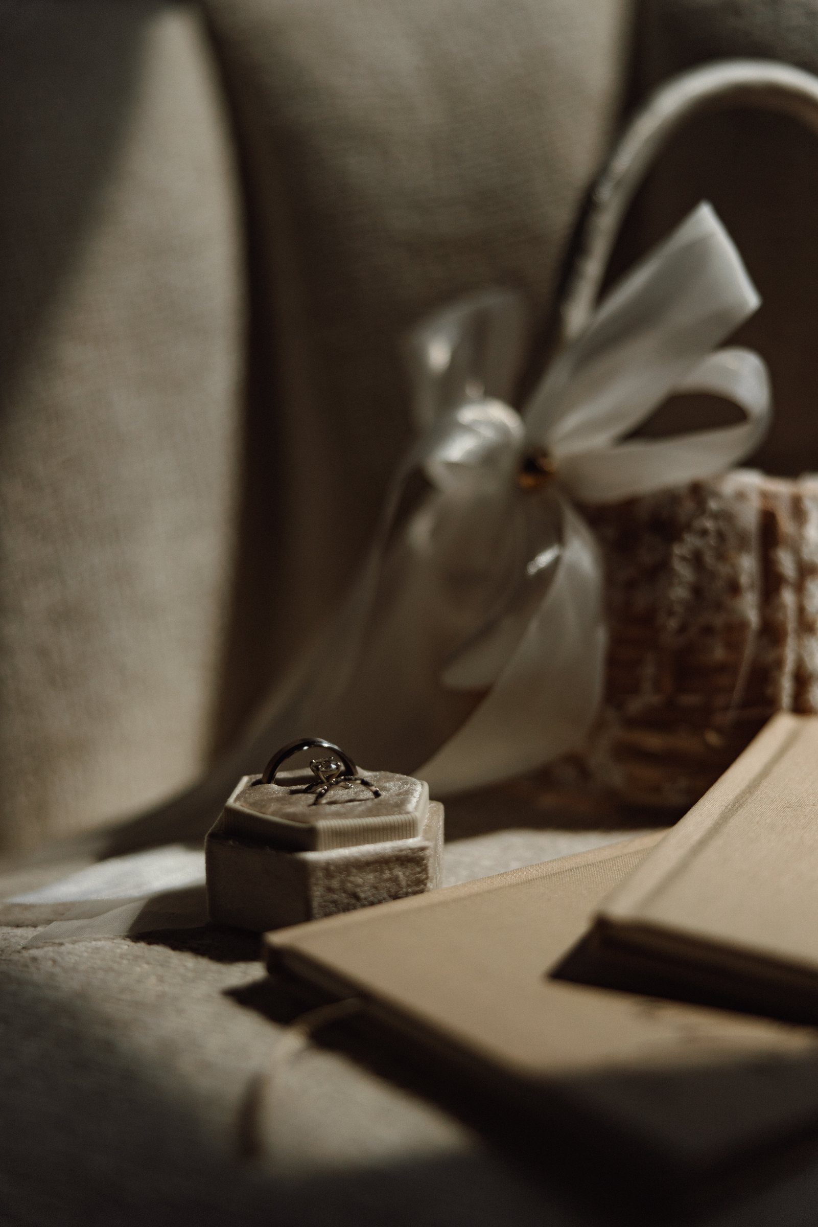 Ring box and vow books resting on linen before the ceremony