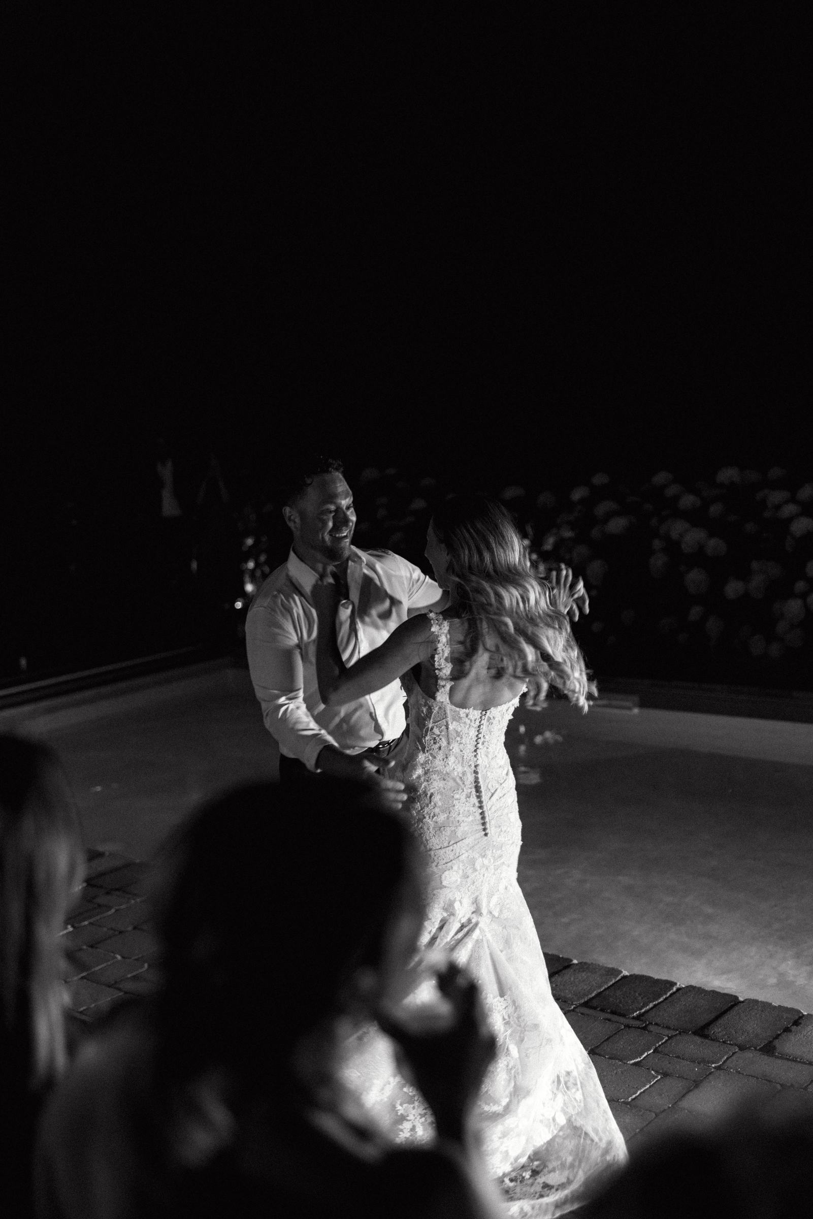 Bride and groom dancing together in the dark after the reception