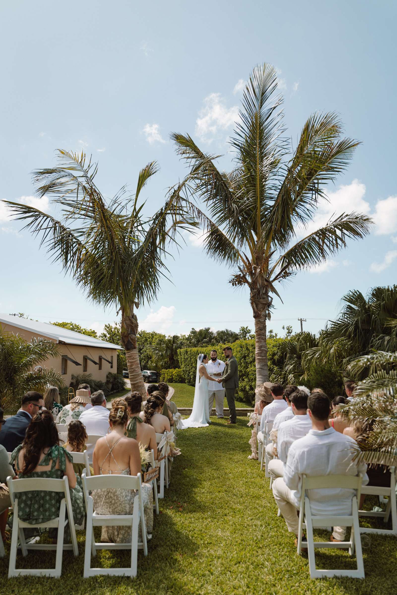 Wedding aisle set on the lawn beneath the palm trees in Bermuda