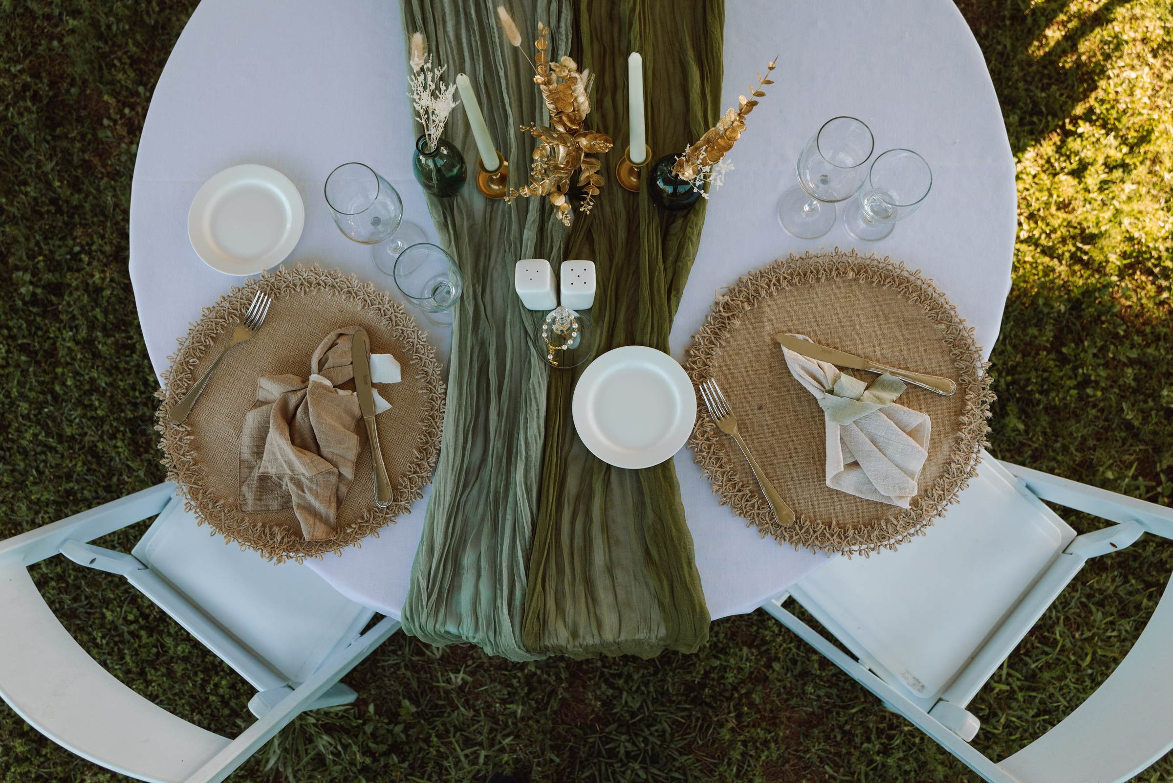 Overhead view of the reception table setting with a green runner