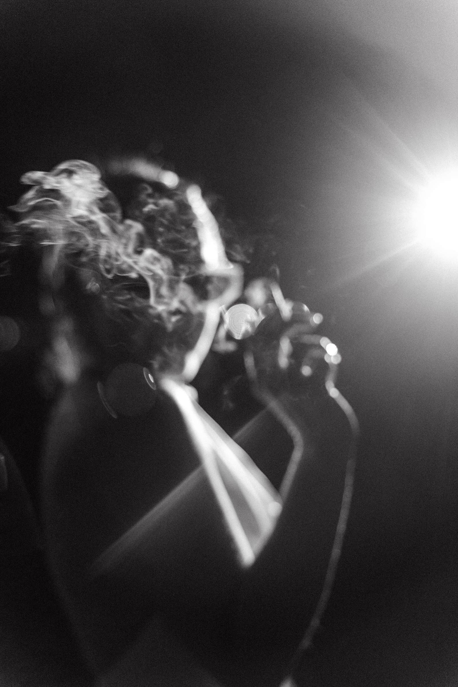 Black and white backlit photograph of the couple close together at night