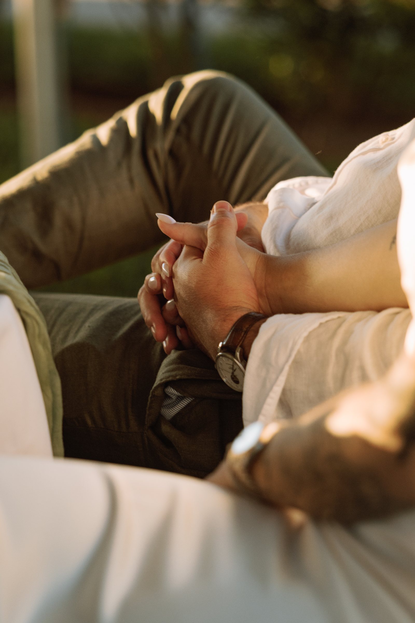 Close up of the couple's hands resting intertwined