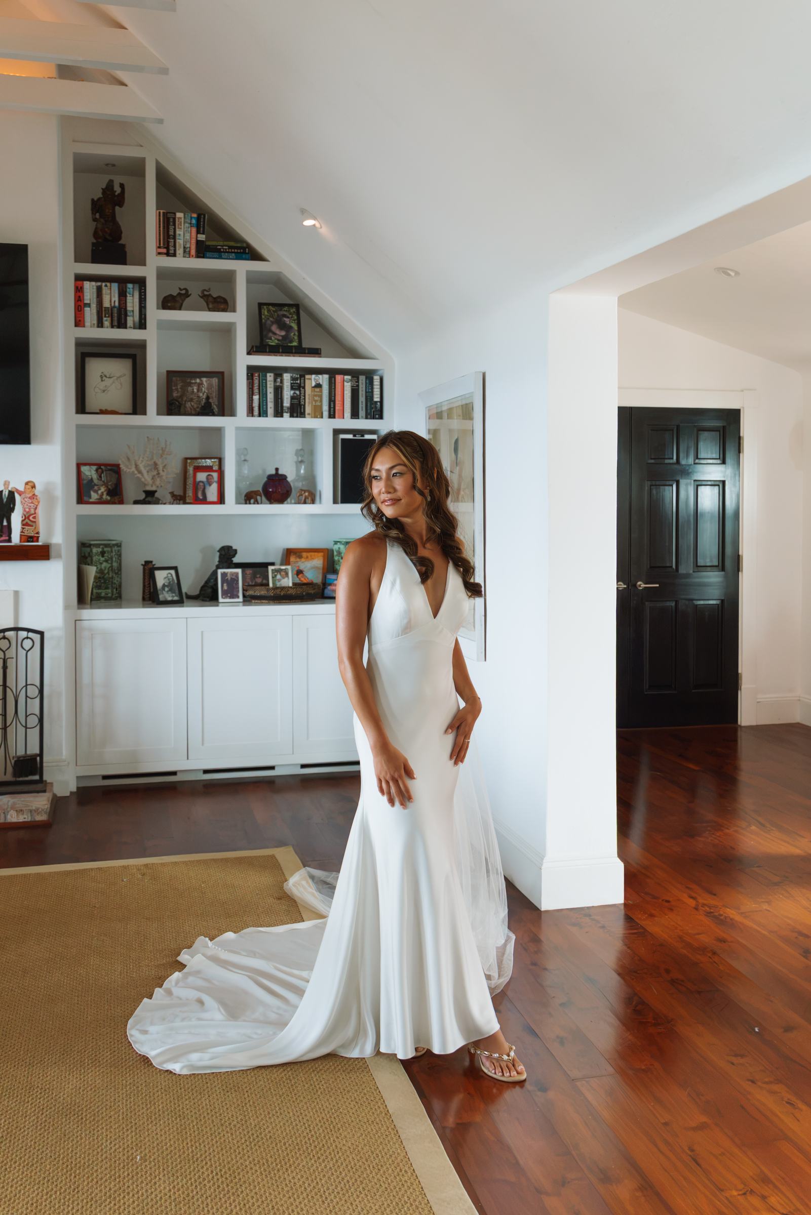Bride alone in the hallway of a Bermuda cottage in her silk gown
