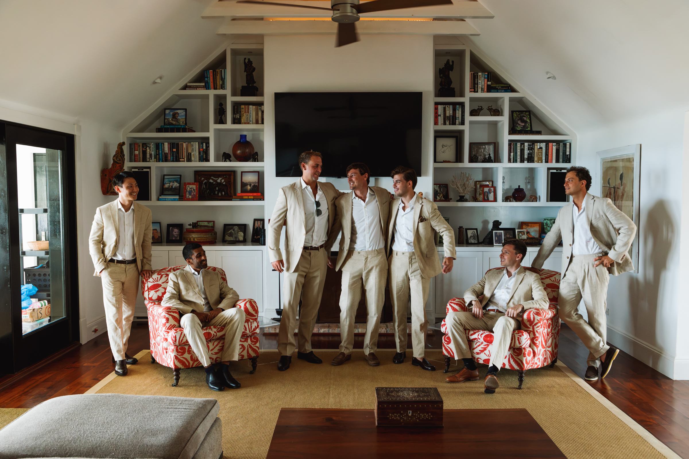Groomsmen in cream suits posed in the living room before the ceremony