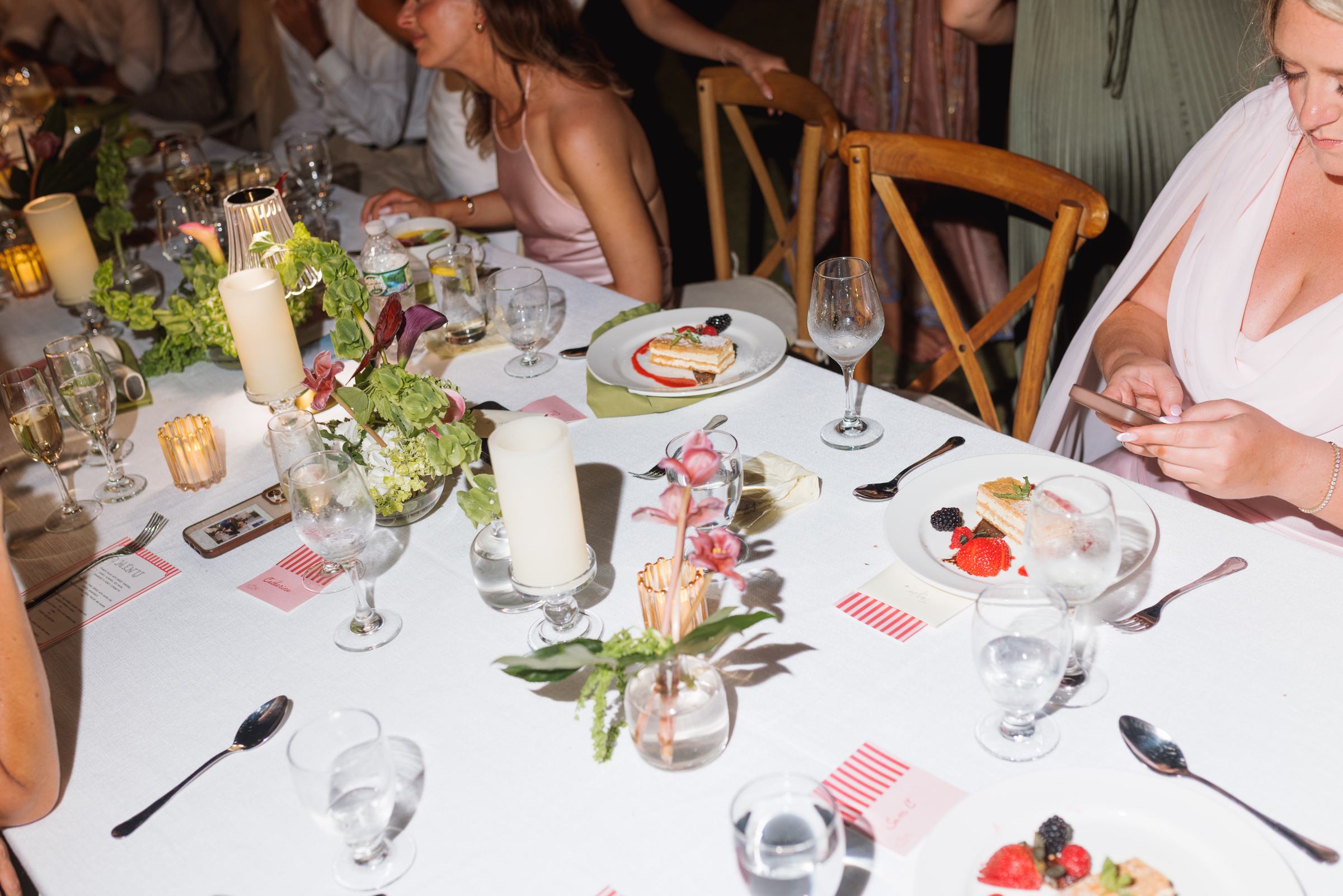 Candlelit dinner table with guests talking at a Bermuda wedding