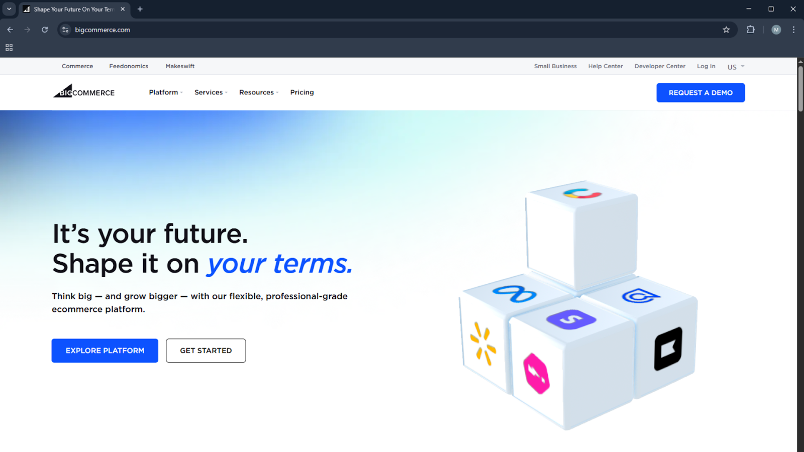 BigCommerce homepage promoting scalability with demo request, platform overview, and cube icons representing integrations - Wolf IQ