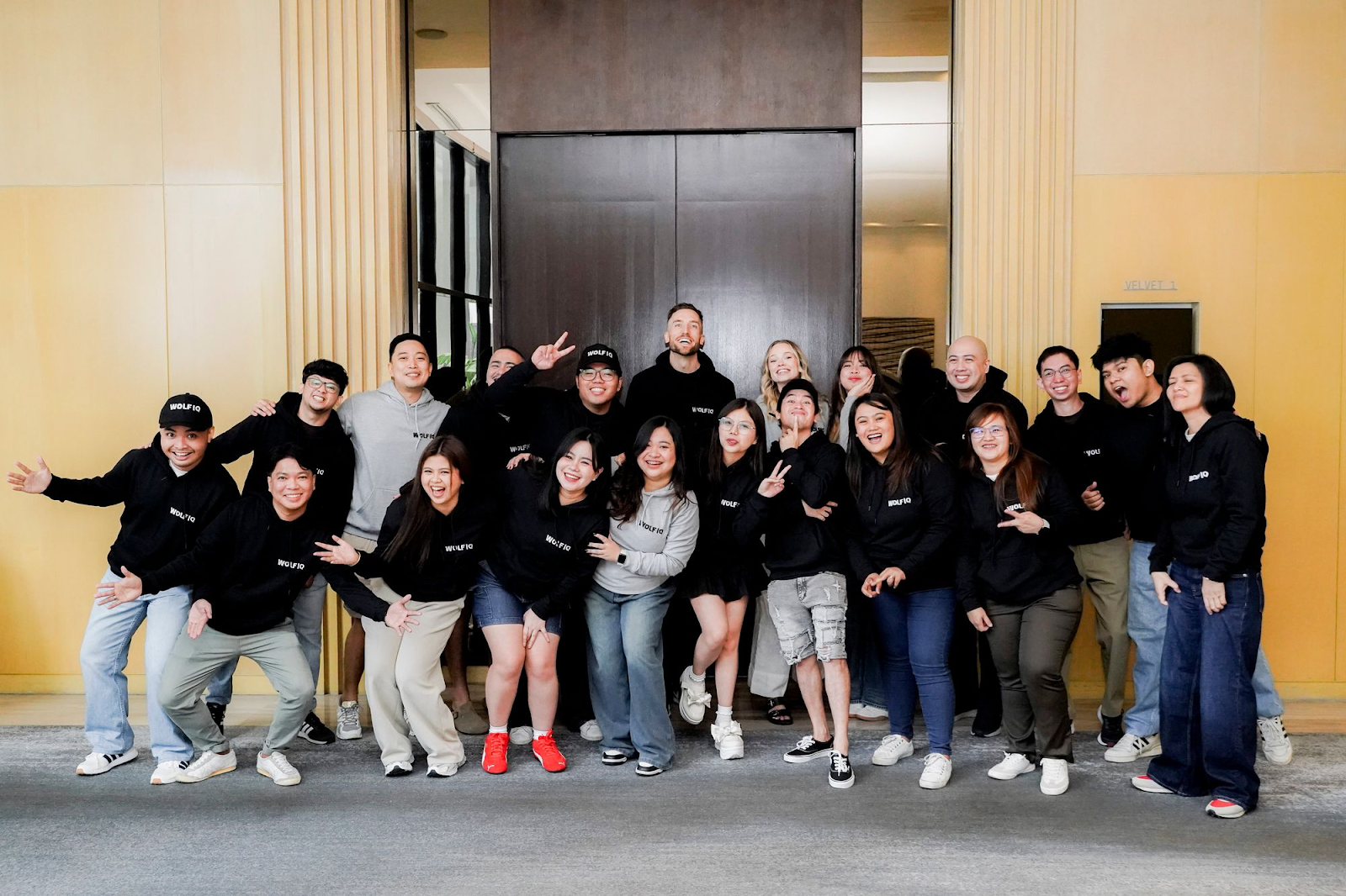 A candid group photo of the Wolf IQ team in matching black hoodies to demonstrate authenticity and brand culture— Wolf IQ