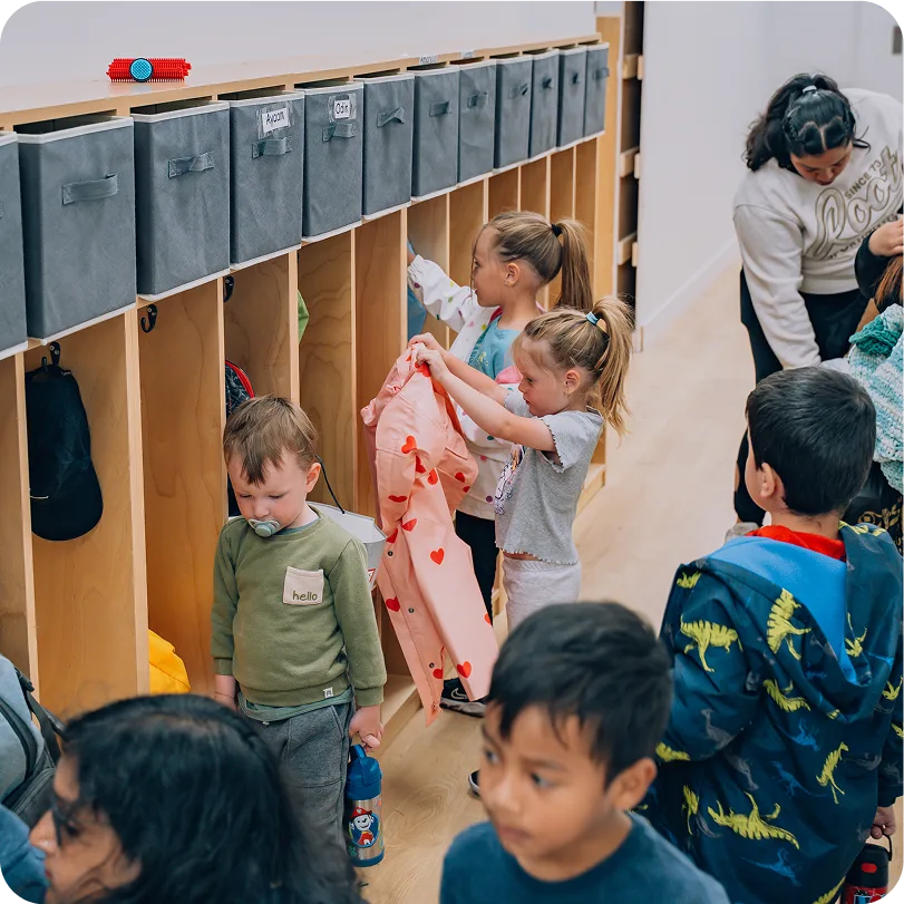 An image with kids next to shelves