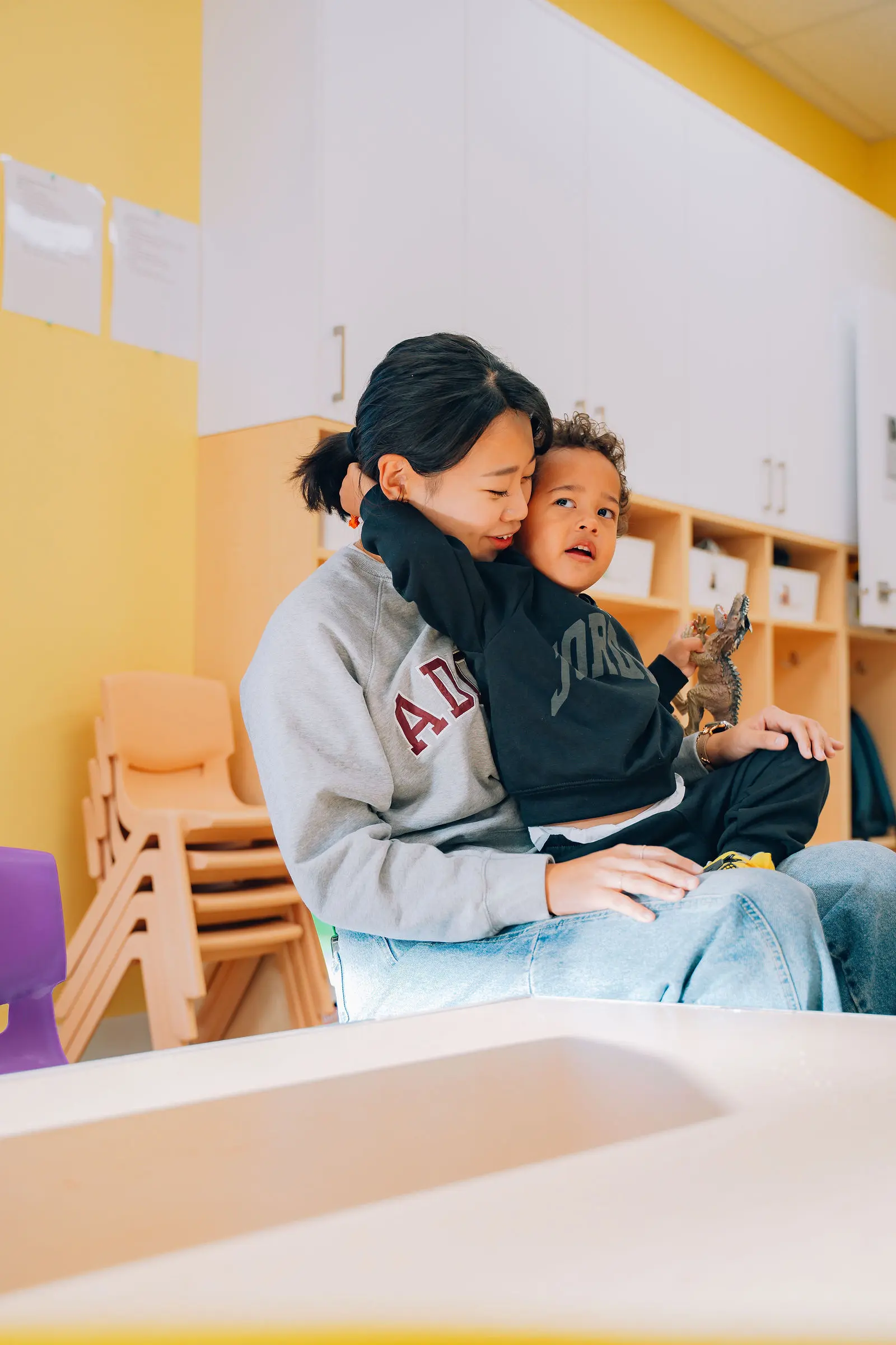 a woman is sitting with a kid