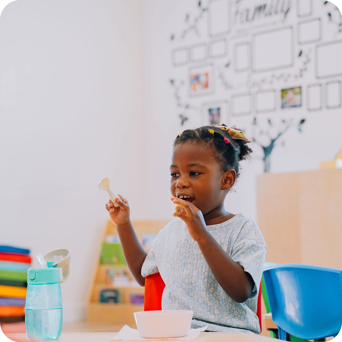 A kid is sitting and playing