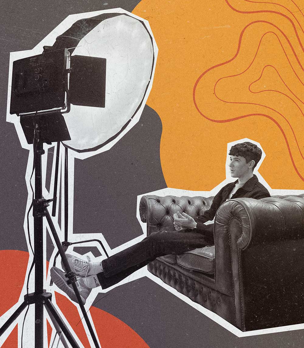 Ryan Yates - Kitto's creative lead sat on a chesterfield suite sofa surrounded by photography lights while being interviewed.