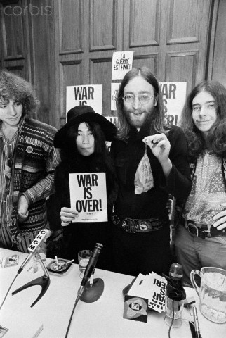 John Lennon and Yoko Ono with "War Is Over" Sign