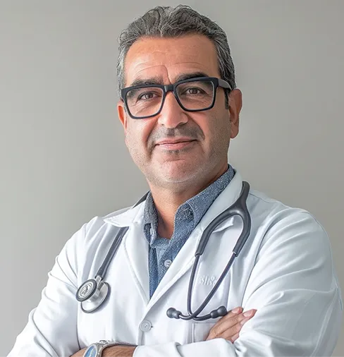 A man in a white lab coat with a stethoscope on his chest.