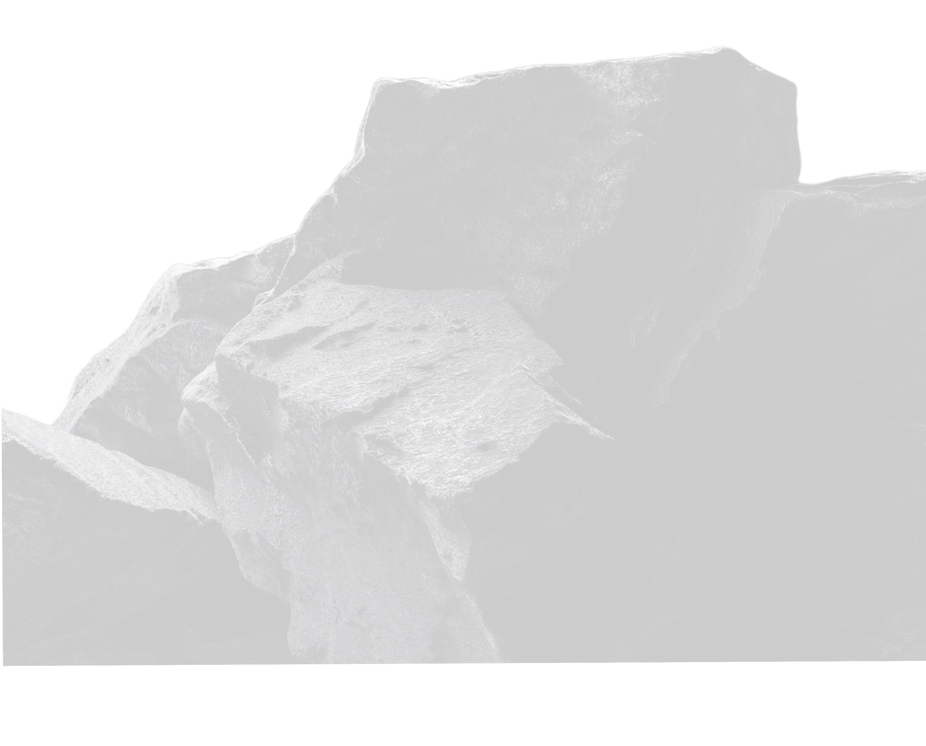 Close-up of textured dark stones stacked against a black background.