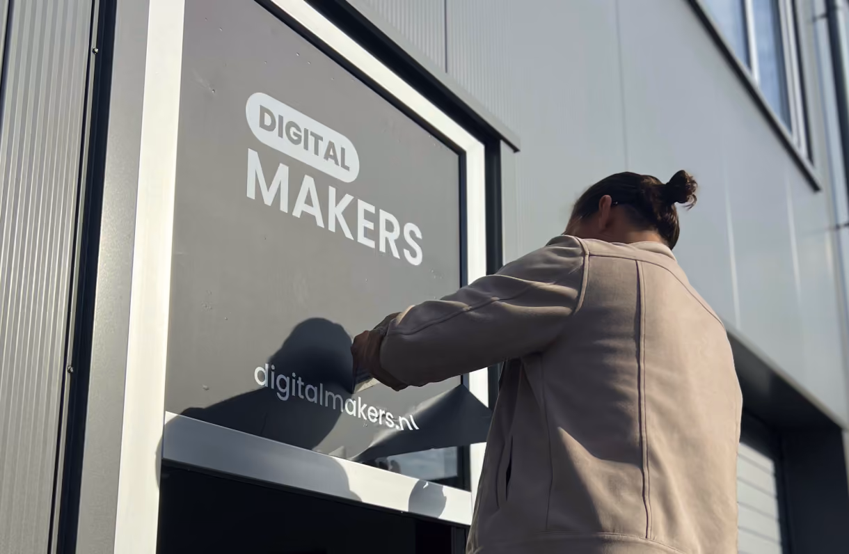 Digitalmakers window sign being applied at the office entrance