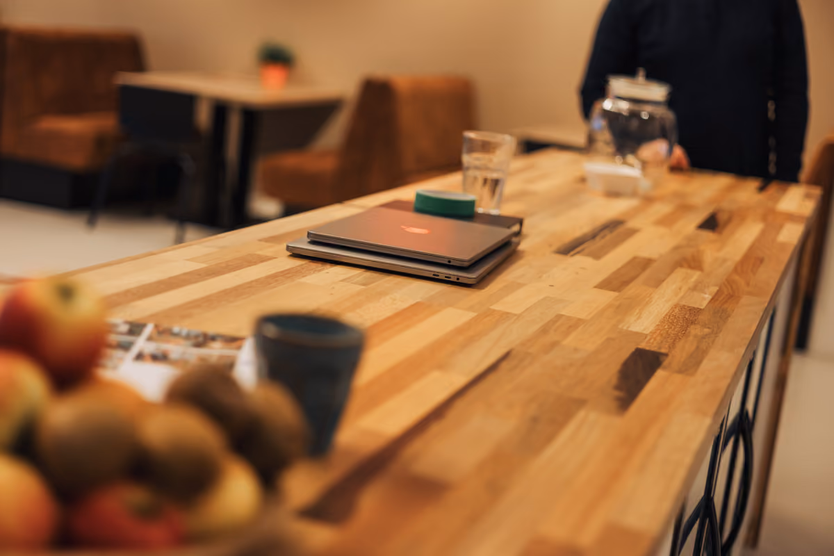 Office table with a notebook, glasses and a bowl of fruit