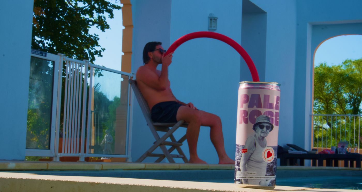 A Bowi can on the edge of the pool, someone drinking in the background